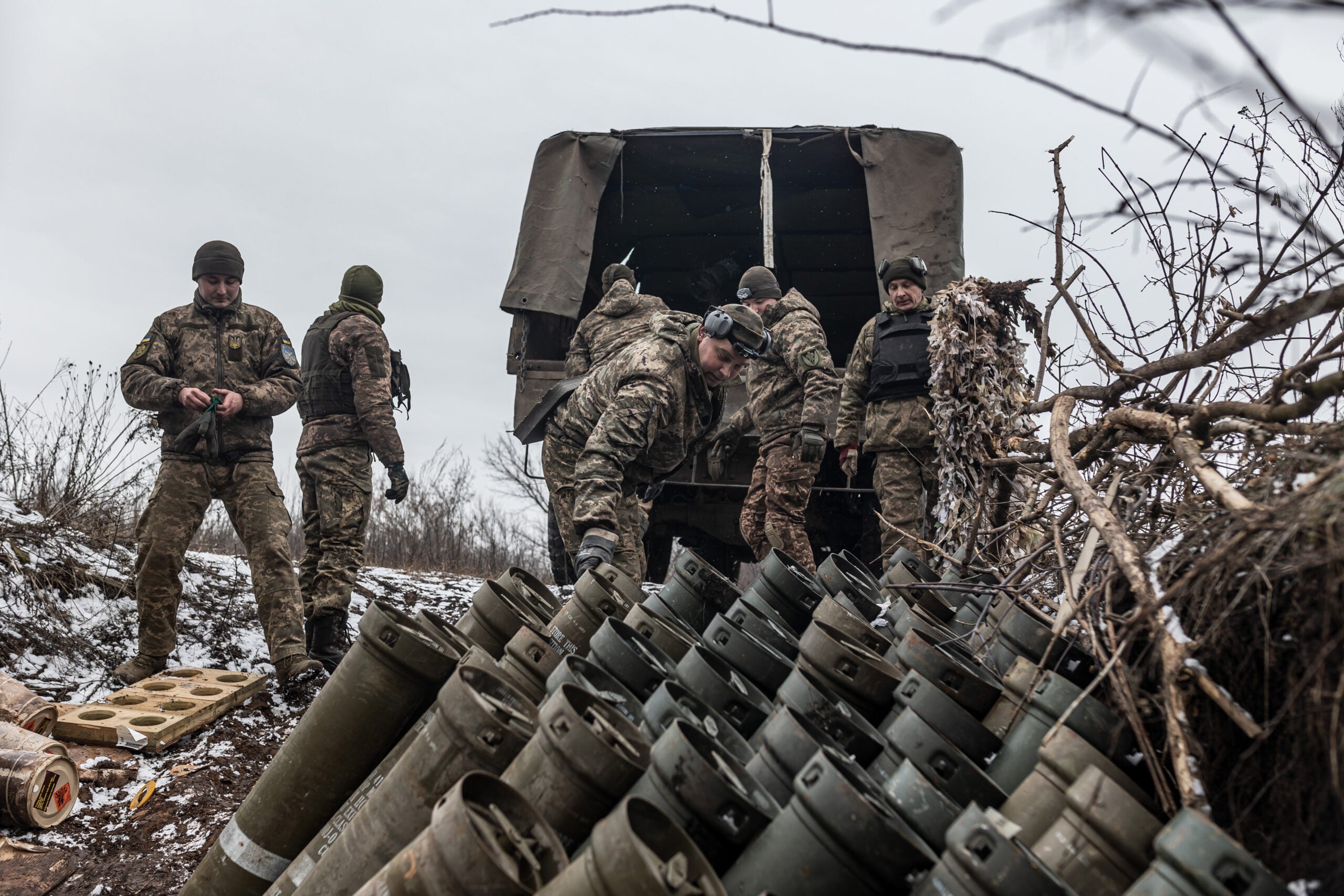 DONETSK OBLAST, UKRAINE - 22 FEBRUARY: Ukrainian soldiers load the remains of explosive charges onto a truck, in their fighting position in the direction of Bakhmut, Donetsk Oblast, Ukraine, 22 February 2024. (Photo by Diego Herrera Carcedo/Anadolu via Getty Images)