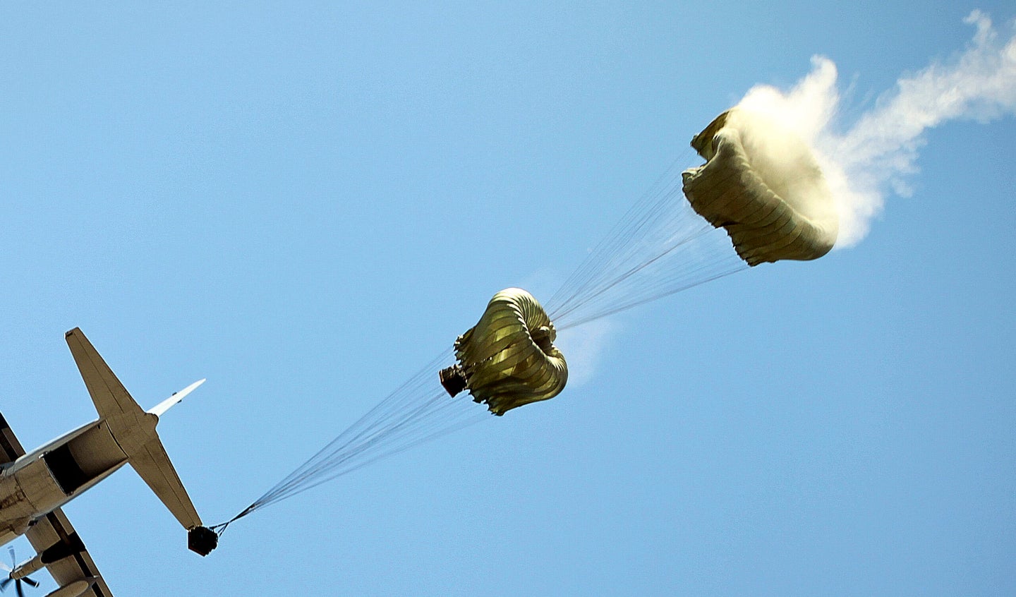 A U.S. Marine Corps C-130 drops container delivery systems with water cargo. Marine Corps photo.