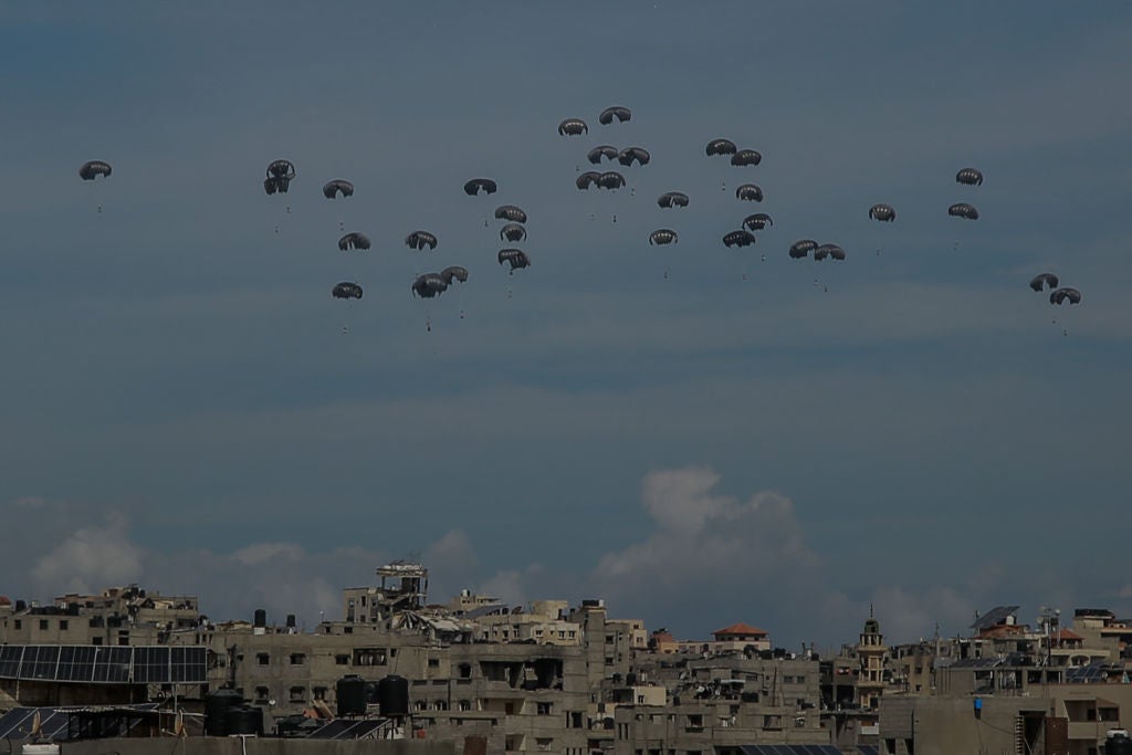 GAZA CITY, GAZA - MARCH 09: Parachutes filled with aid boxes float down as planes drop humanitarian aid around various regions in the northern Gaza, Gaza on March 09, 2024. (Photo by Omar Qattaa/Anadolu via Getty Images)