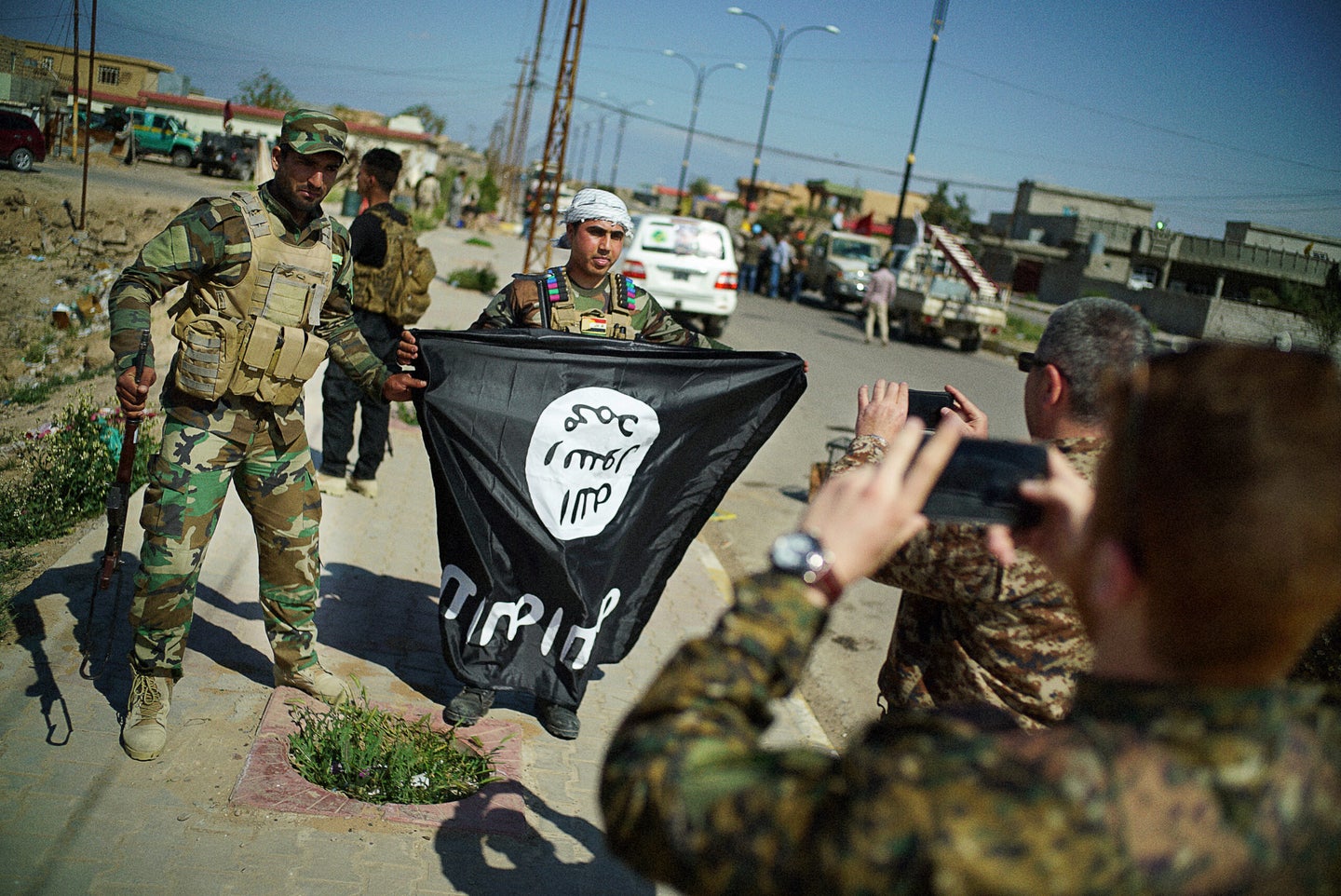 ISIS’s claim to be behind a terrorist attack in Moscow proves the group is still a global threat with branches in areas like Central Asia and Africa, a Pentagon official said Monday. Photo shows Shia militiamen posing for pictures with a captured Islamic State flag on the outskirts of the Iraqi city of Tikrit on March 17, 2015, in Tikrit, Iraq.  (Photo by Ayman Oghanna/Getty Images)