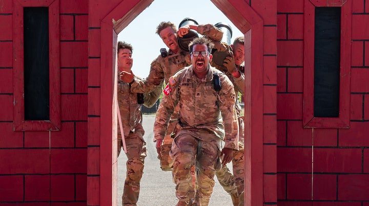 Staff Sgt. Dwayne Jones, front, and his partner 1st Lt. Austin Chambers, right, run through the castle gate that marks the finish line  of the 2024 Best Sapper competition, just ahead of a competing team. The pair, from the 299th Brigade Engineer Battalion at Fort Carson, finished 24th out of 50 teams in the 4-day competition. U.S. Army photo by Amanda Sullivan.