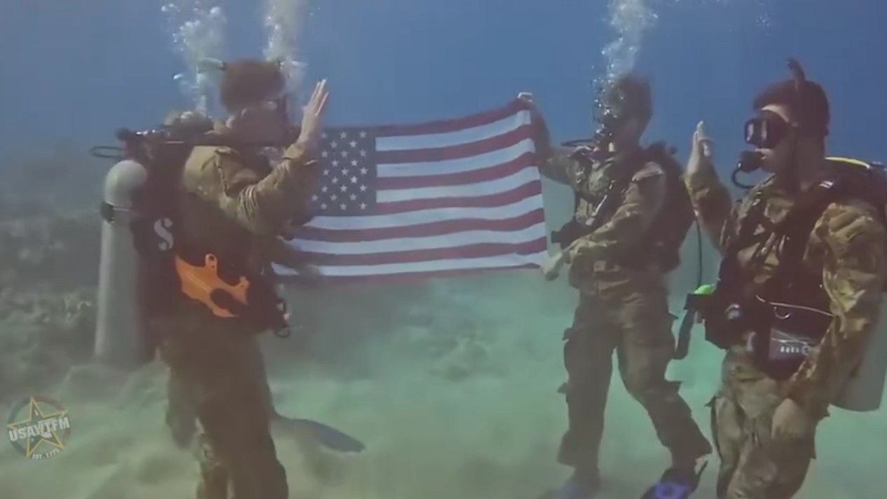 This soldier is taking others scuba diving for their reenlistment