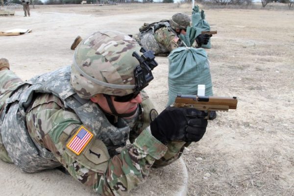 Sgt. 1st Class Rocky Butler, a signal support systems specialist from Regimental Headquarters and Headquarters Troop, 3rd Cavalry Regiment, lays in the prone position with the new M17 Modular Handgun System for the first time during the troop's weapons qualification range Jan. 19, 2018 at Fort Hood, Texas.