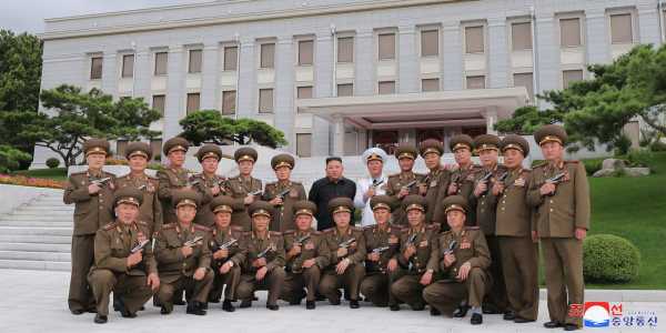 Flanked by pistol-packing generals, Kim Jong Un appears ready to drop the hottest diss track of 2020