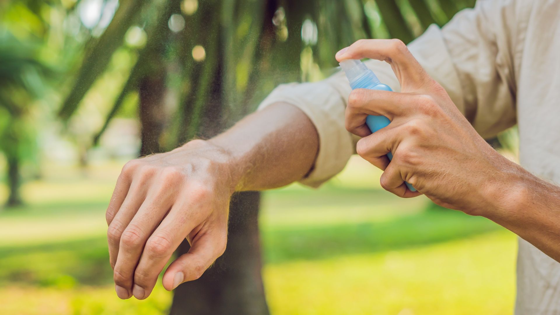 Spraying mosquito repellent.