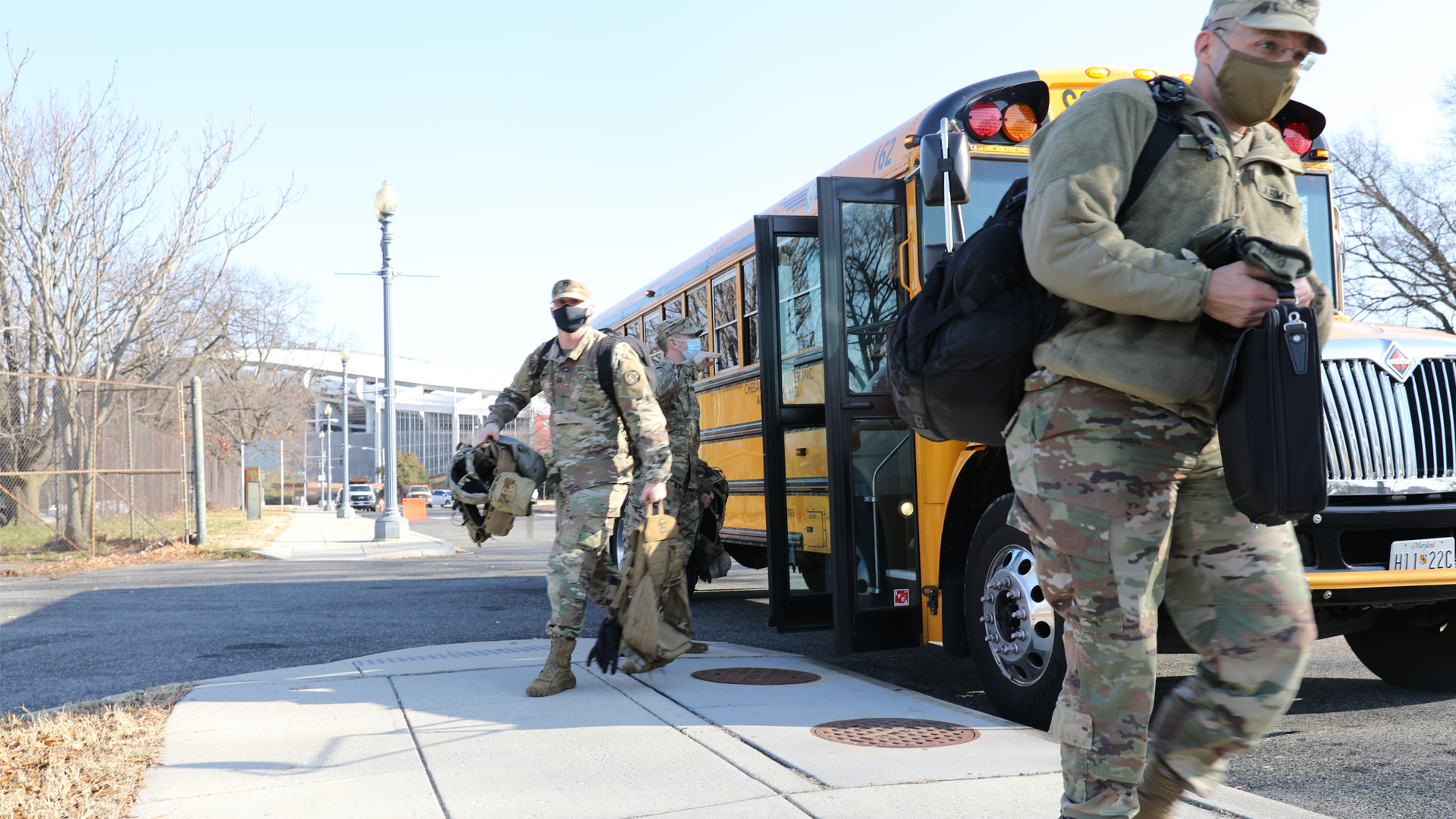 National Guard soldiers get off bus