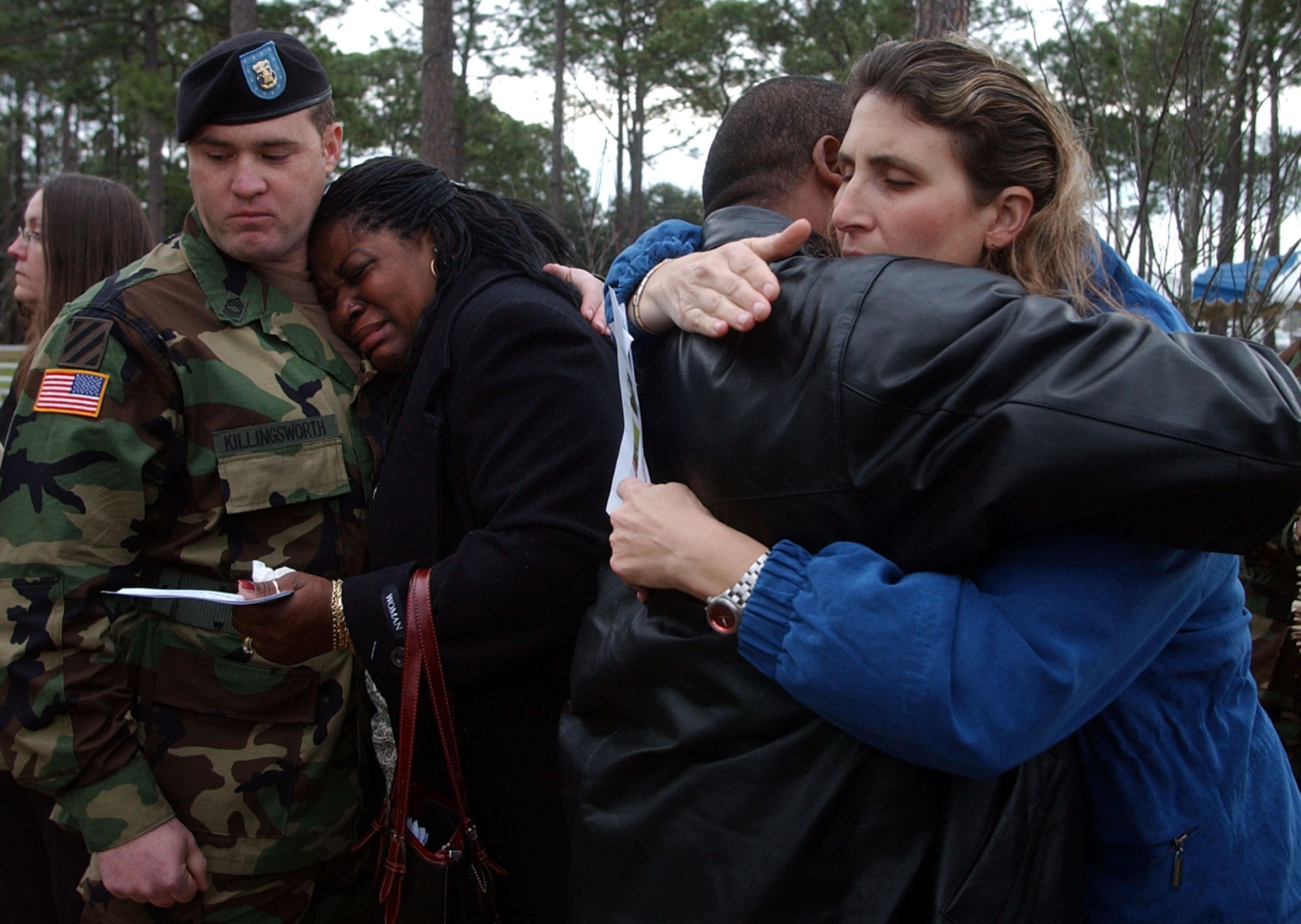 Kasinal Cashe, left, crys on the shoulder of a unidentifed soldier Thursday, Dec. 15, 2005, for her brother U.S. Army Sgt. 1st Class Alwyn Cashe of Oviedo, Fla., along with Vicki Taylor, right, while at a tree dedication ceremony in Fort Stewart, Ga. Cashe died in Iraq from wounds he suffered while rescuing other soldiers trapped inside a Bradley Fighting Vehicle that was destroyed by a roadside bomb. The tree dedication ceremony was the second largest for those killed in action while serving with the Army's 3rd Infantry Division.