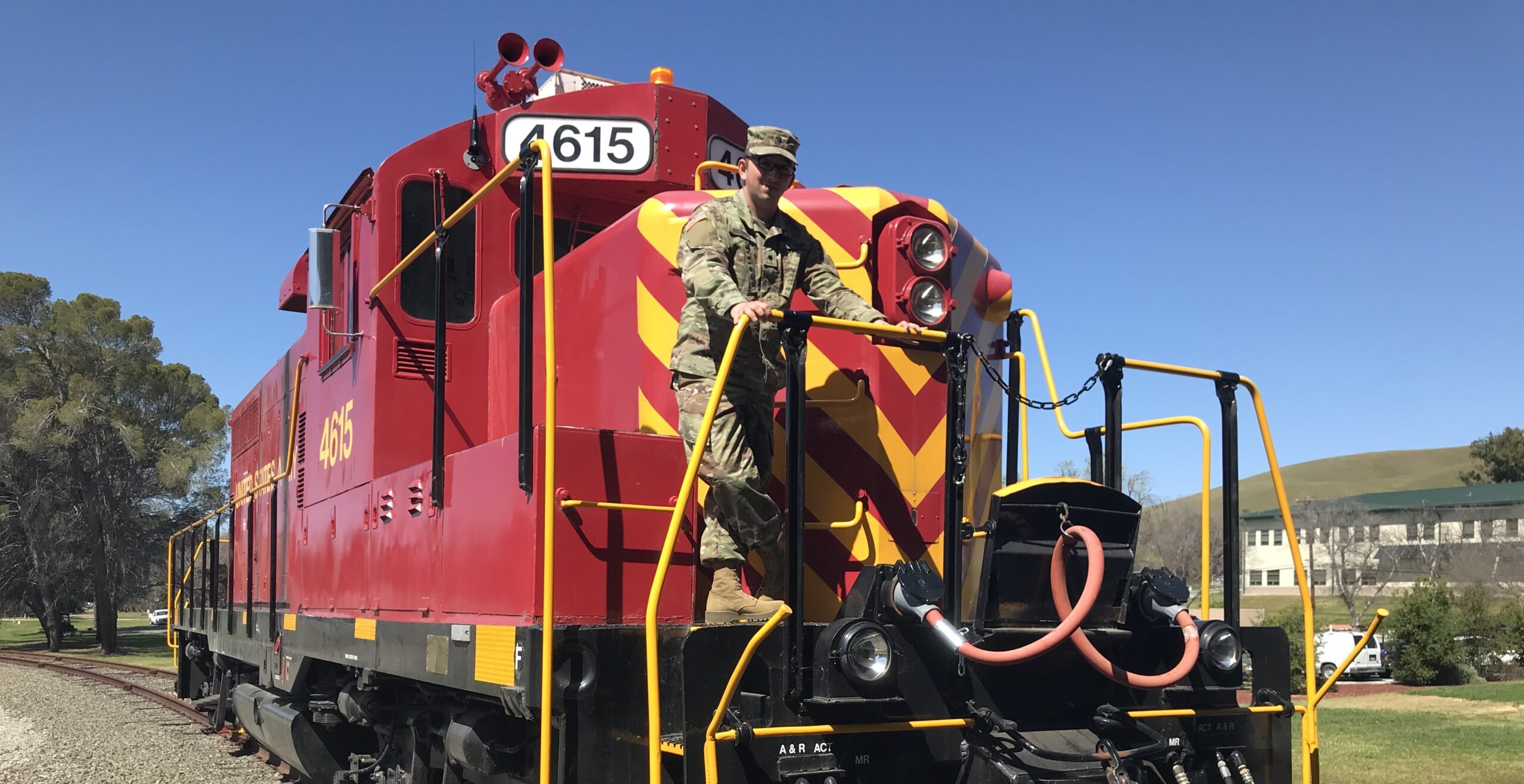 Josh Biggers stands in front of a train.