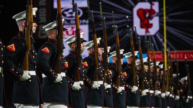 U.S. Marines with the United States Marine Corps Silent Drill Platoon execute their "long line" sequence during a half-time performance at a Gainesville High School football game during Marine Week Atlanta in Gainesville, Ga., Aug. 29, 2025. The year 2025 marks the 250th anniversary of the United States Marine Corps, a milestone that highlights the legacy, transformation and enduring spirit of the Corps since 1775. Throughout the year, Marines across the globe will commemorate this anniversary by honoring the service and sacrifice of those who served before them and by remaining faithful to the motto Semper Fidelis. (U.S. Marine Corps photo by Cpl. Christopher Prelle)