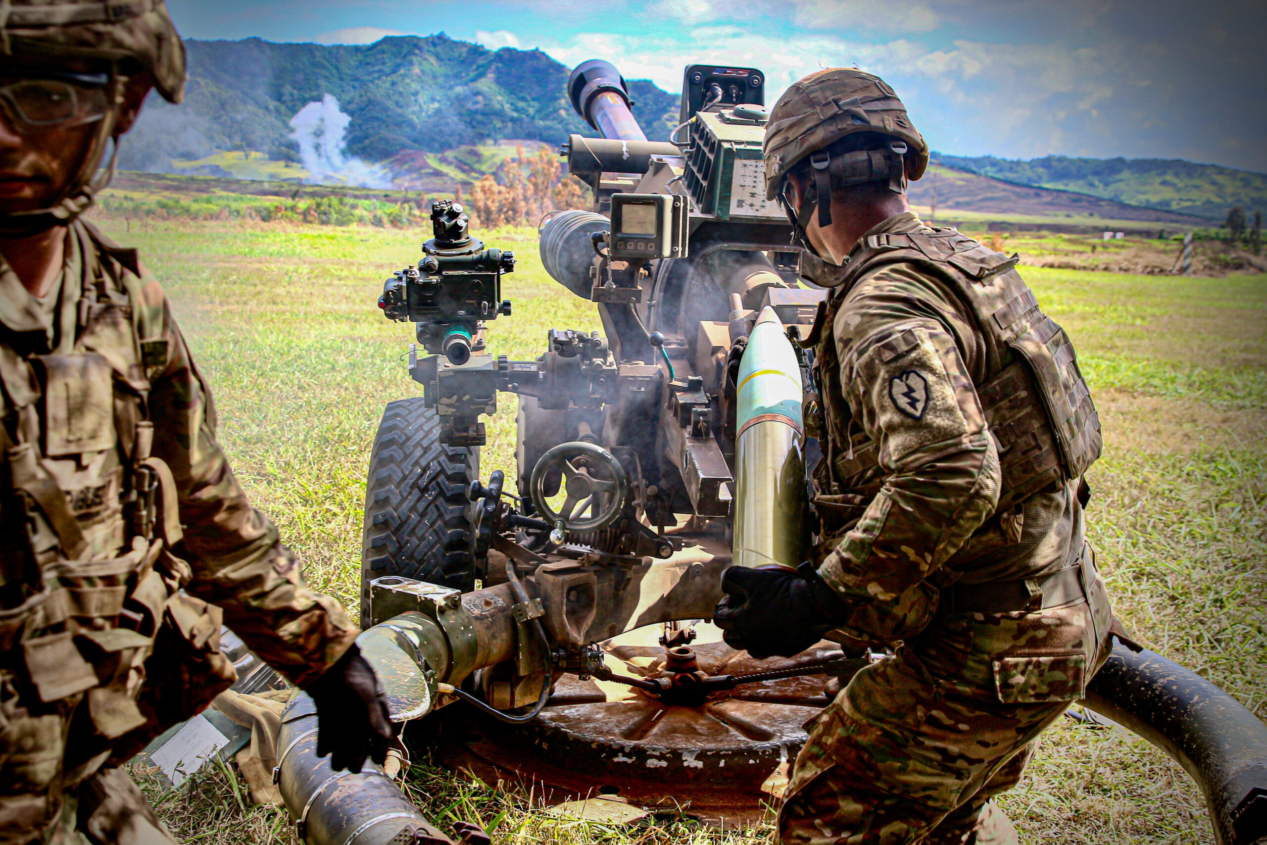 Soldiers firing artillery rounds