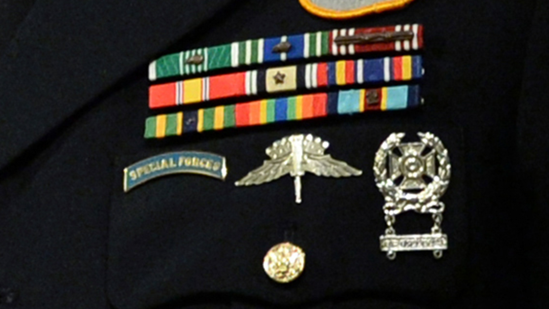 An Army soldiers ribbons, awards, and skill badges.