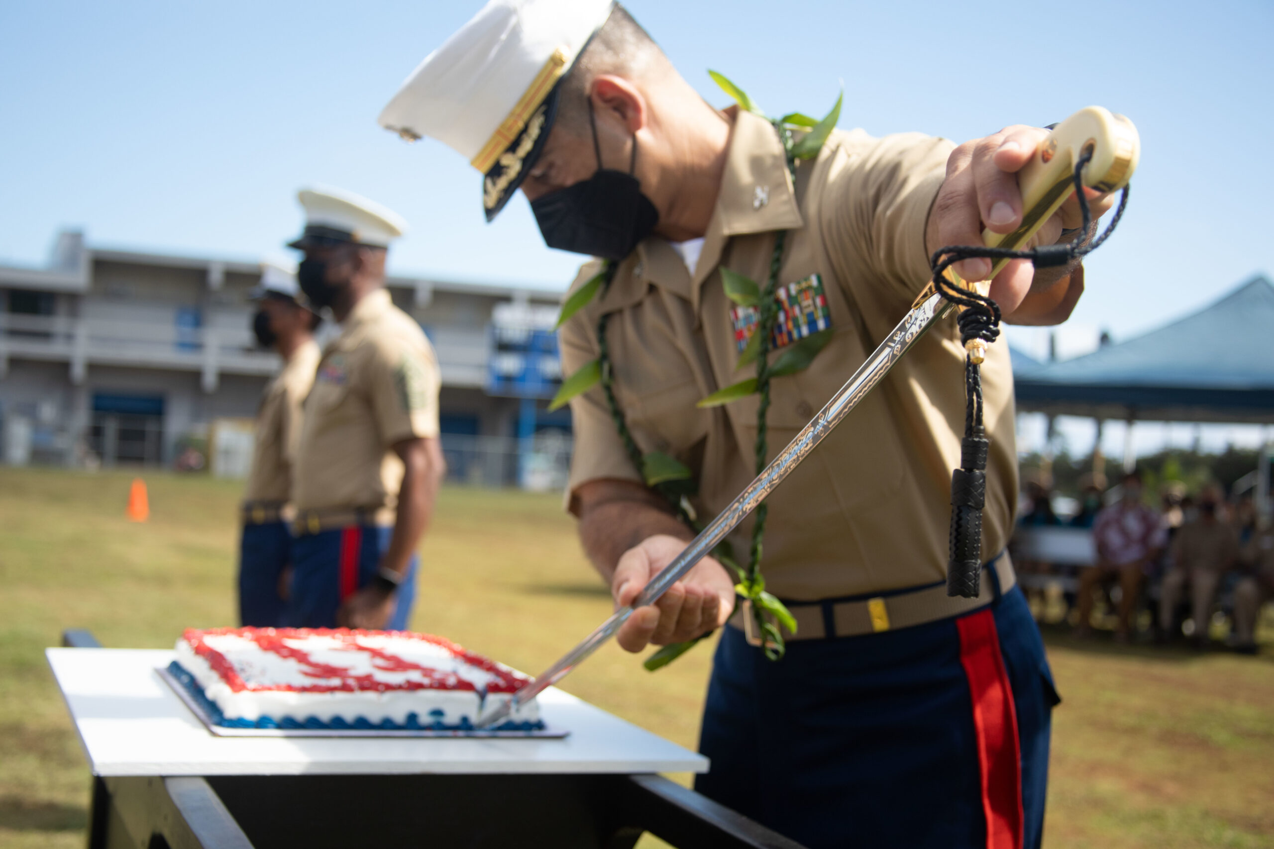 U.S. Marine Corps Col. Speros Koumparakis uses a Mameluke sword to slice a cake during a Marine Corps Birthday ceremony in Hawaii.