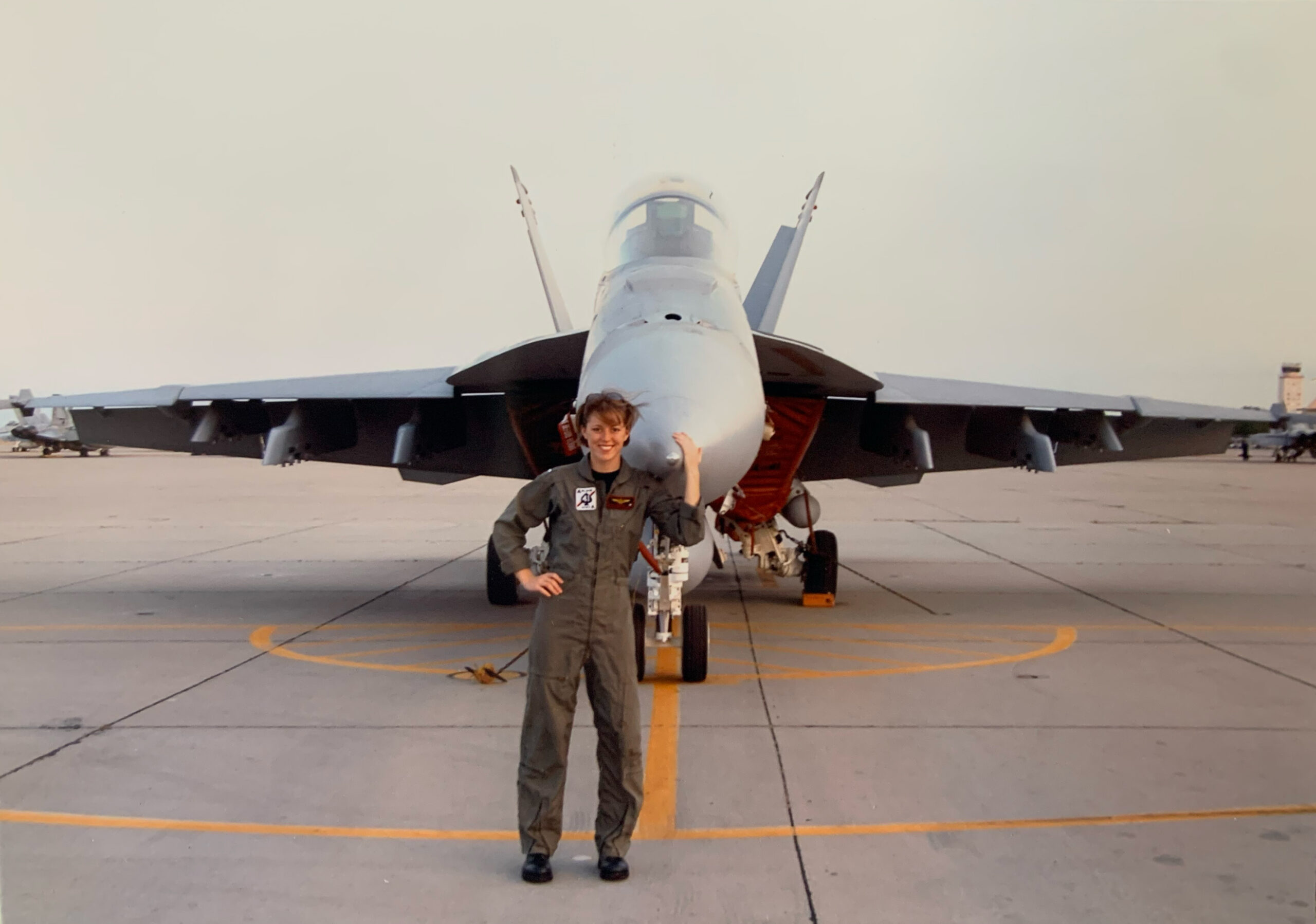 Alex Dietrich standing in front of her F/A-18 Super Hornet.