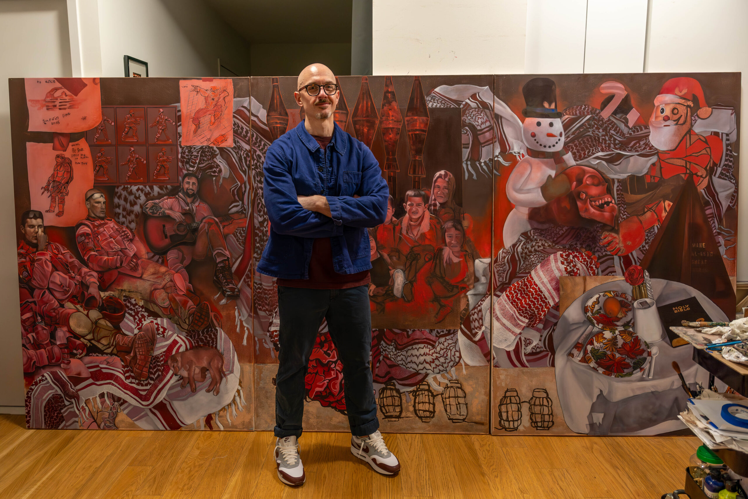 Mitchel Coffman with his triptych painting.