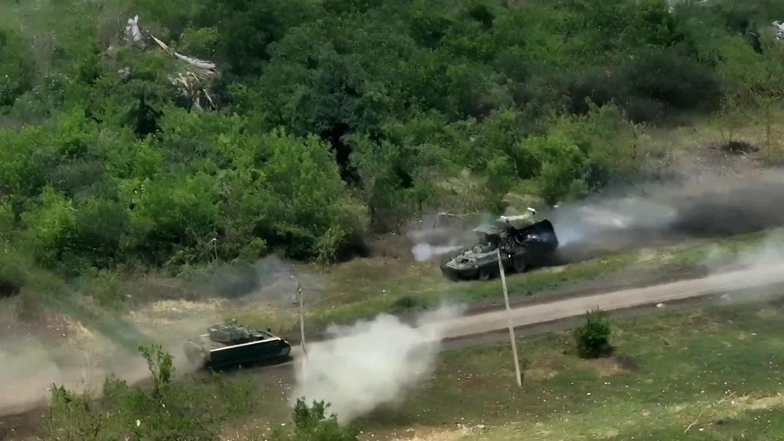 A Ukrainian Bradley Infantry Fighting Vehicle, left, charges toward a Russian BTR-82. (Screenshot via Ukraine's Ministry of Defense on X)