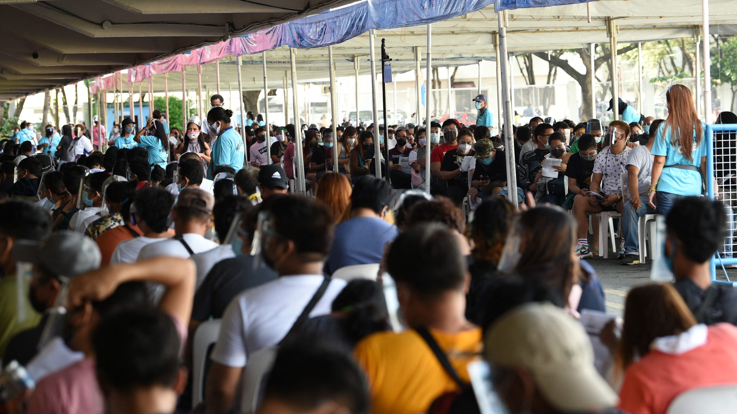 TOPSHOT - Residents queue for vaccination in Marikina City, suburban Manila on August 6, 2021, as authorities imposed another lockdown to slow the spread of the hyper-contagious Delta variant and ease pressure on hospitals while trying to avoid crushing economic activity. (Photo by Ted ALJIBE / AFP) (Photo by TED ALJIBE/AFP via Getty Images)