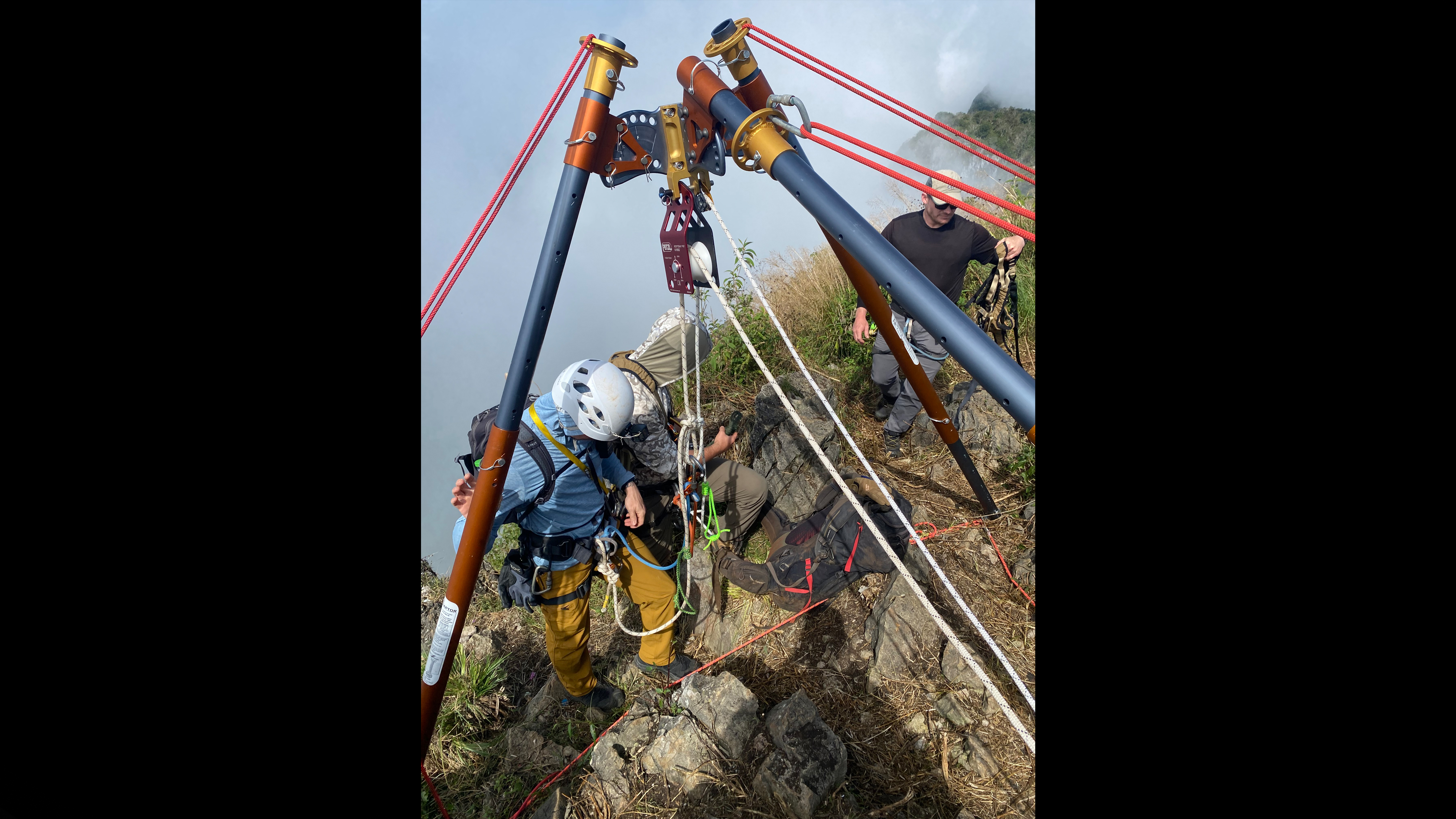 DPAA investigation team members preparing to descend down the cliffside of the former Lima Site 85.