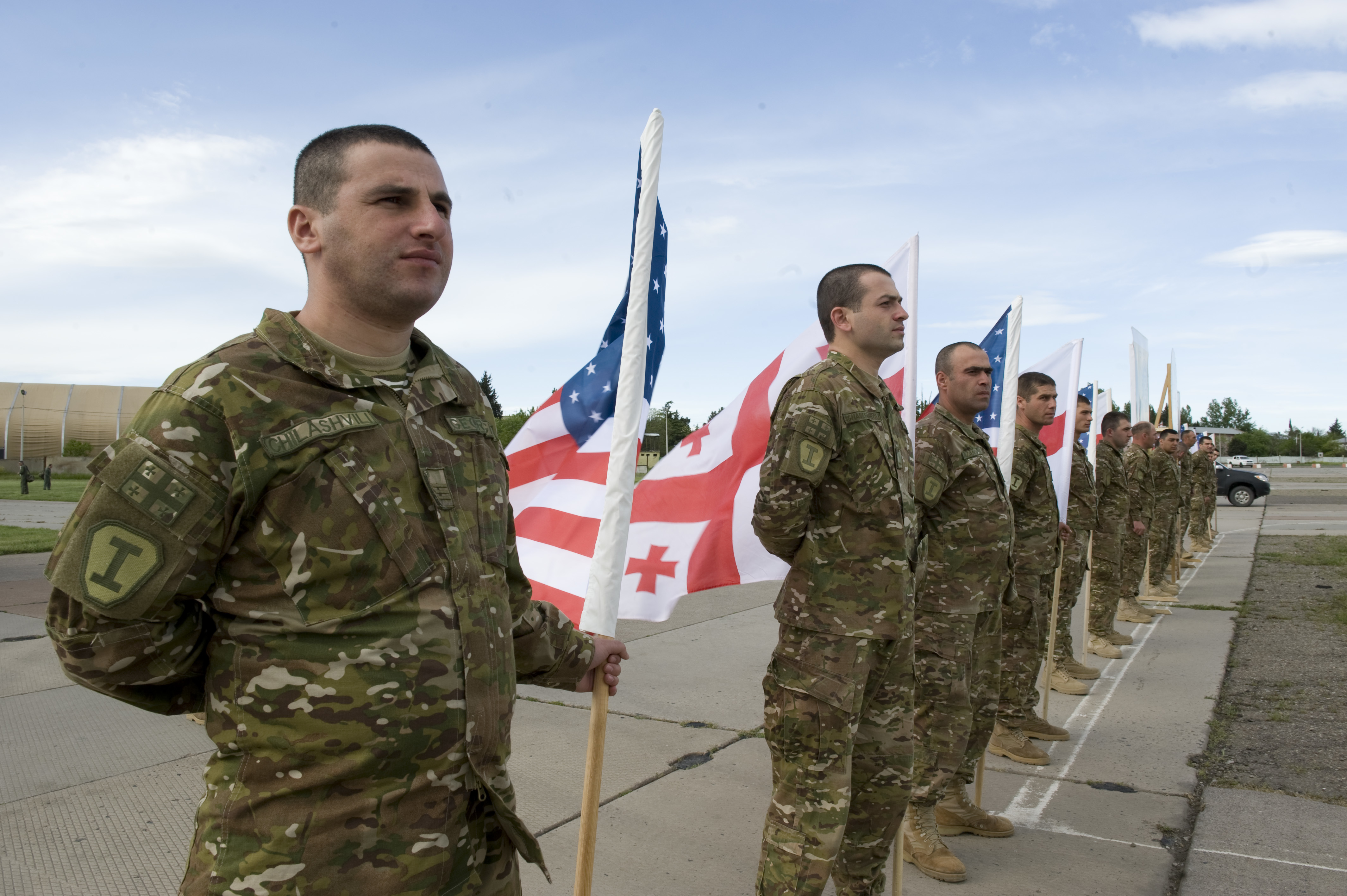 A Georgian soldier waits to welcome paratroopers from Troop C, 1st Squadron, 91st Cavalry Regiment 173rd Airborne Brigade here, May 8. The paratroopers arrived from Grafenwoehr, Germany, and are here to train alongside Soldiers from A Company, 2nd Battalion, 7th Infantry Regiment, 1st Brigade, 3rd Infantry Division and the Georgian Land Forces in Exercise Noble Partner 15.Noble Partner is a Georgian and U.S. military training exercise taking place at Vaziani Training Area, Georgia, from 11 to 25 May. This exercise is a critical part of Georgia’s training for their contribution of a light infantry company to the NATO Response Force. While Georgia is not a member of NATO, it and other NATO partners voluntarily contribute to the NRF. Exercise Noble Partner provides an opportunity to continue the U.S. training relationship with the Georgian Armed Forces as the sponsor of Georgia’s participation in the NRF. (Photo by Sgt. Daniel Cole, U.S. Army Europe Public Affairs)