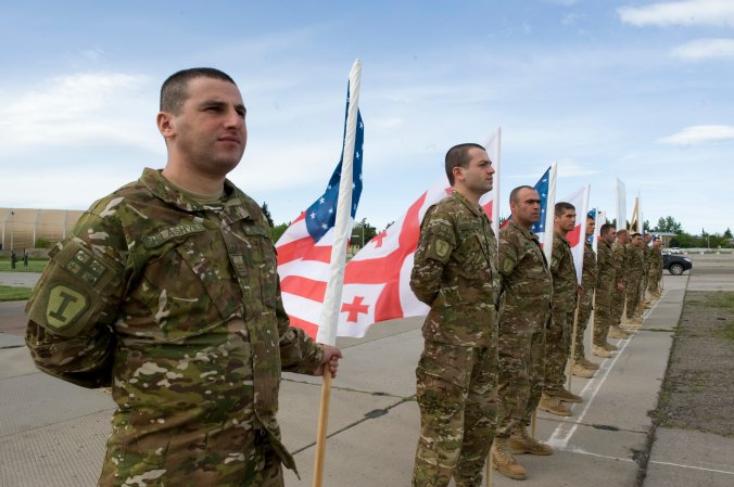 A Georgian soldier waits to welcome paratroopers from Troop C, 1st Squadron, 91st Cavalry Regiment 173rd Airborne Brigade here, May 8. The paratroopers arrived from Grafenwoehr, Germany, and are here to train alongside Soldiers from A Company, 2nd Battalion, 7th Infantry Regiment, 1st Brigade, 3rd Infantry Division and the Georgian Land Forces in Exercise Noble Partner 15.Noble Partner is a Georgian and U.S. military training exercise taking place at Vaziani Training Area, Georgia, from 11 to 25 May. This exercise is a critical part of Georgia’s training for their contribution of a light infantry company to the NATO Response Force. While Georgia is not a member of NATO, it and other NATO partners voluntarily contribute to the NRF. Exercise Noble Partner provides an opportunity to continue the U.S. training relationship with the Georgian Armed Forces as the sponsor of Georgia’s participation in the NRF. (Photo by Sgt. Daniel Cole, U.S. Army Europe Public Affairs)