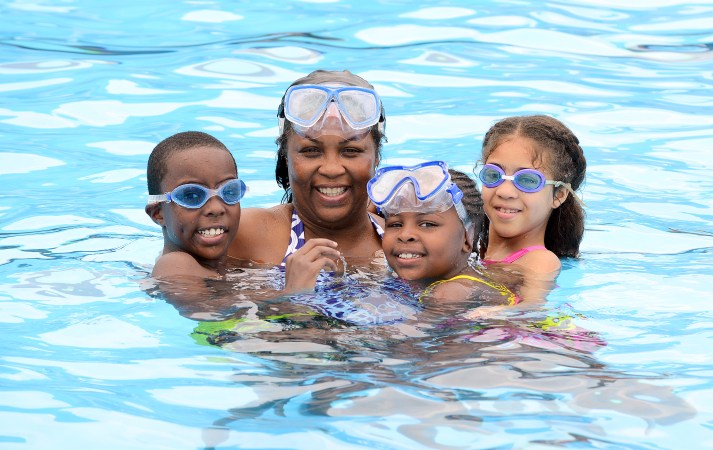 Brandon Respress, 9, Ruby Cooper, military retiree, Ariana Respress, 7, and Makayla Taylor, 8, enjoy good family fun in the outdoor pool at Robins Air Force Base’s Heritage Club July 28. The facility, which is operated by the 78th Force Support Squadron, offers a great way for patrons to beat the heat during a very hot summer. (U.S. Air Force photo by Tommie Horton)