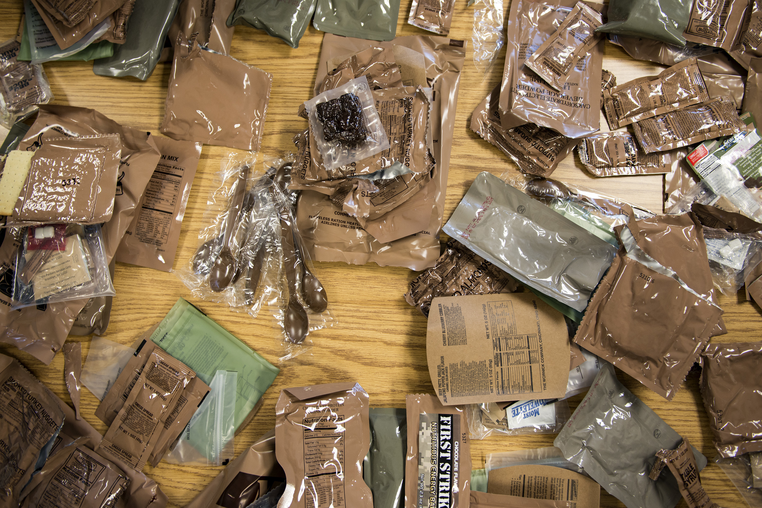 Meals, ready to eat (MREs) rest on a table during an MRE open-package inspection, April 6, 2018, at Moody Air Force Base, Ga. Airmen from Public Health examine the MREs for defects and overall quality and determine whether they’ll be utilized here, at other bases or to condemn the batch. Public Health monitors more than 8,400 MREs yearly to ensure they are safe and fit for consumption, so as to maintain a healthy fighting force. (U.S. Air Force photo by Airman 1st Class Erick Requadt)