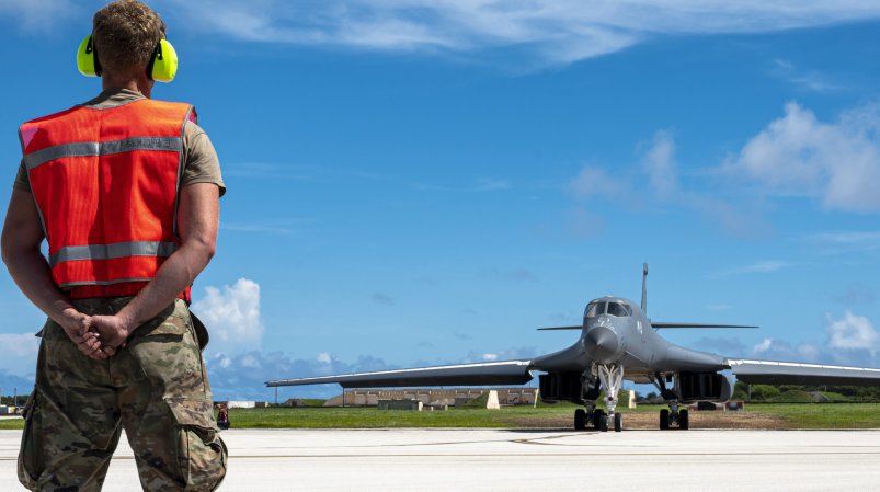 An aircraft maintainer, assigned to 34th Aircraft Maintenance Unit, prepares to marshal a U.S. Air Force B-1B Lancer, assigned to 34th Expeditionary Bomb Squadron, to takeoff from Andersen Air Force Base, Guam, to support a Bomber Task Force mission, June 29. Bomber Task Force missions provide opportunities to train alongside our allies and partners to build interoperability and bolster our collective ability to support a free and open Indo-Pacific. (U.S. Air Force photo by Master Sgt. Nicholas Priest)