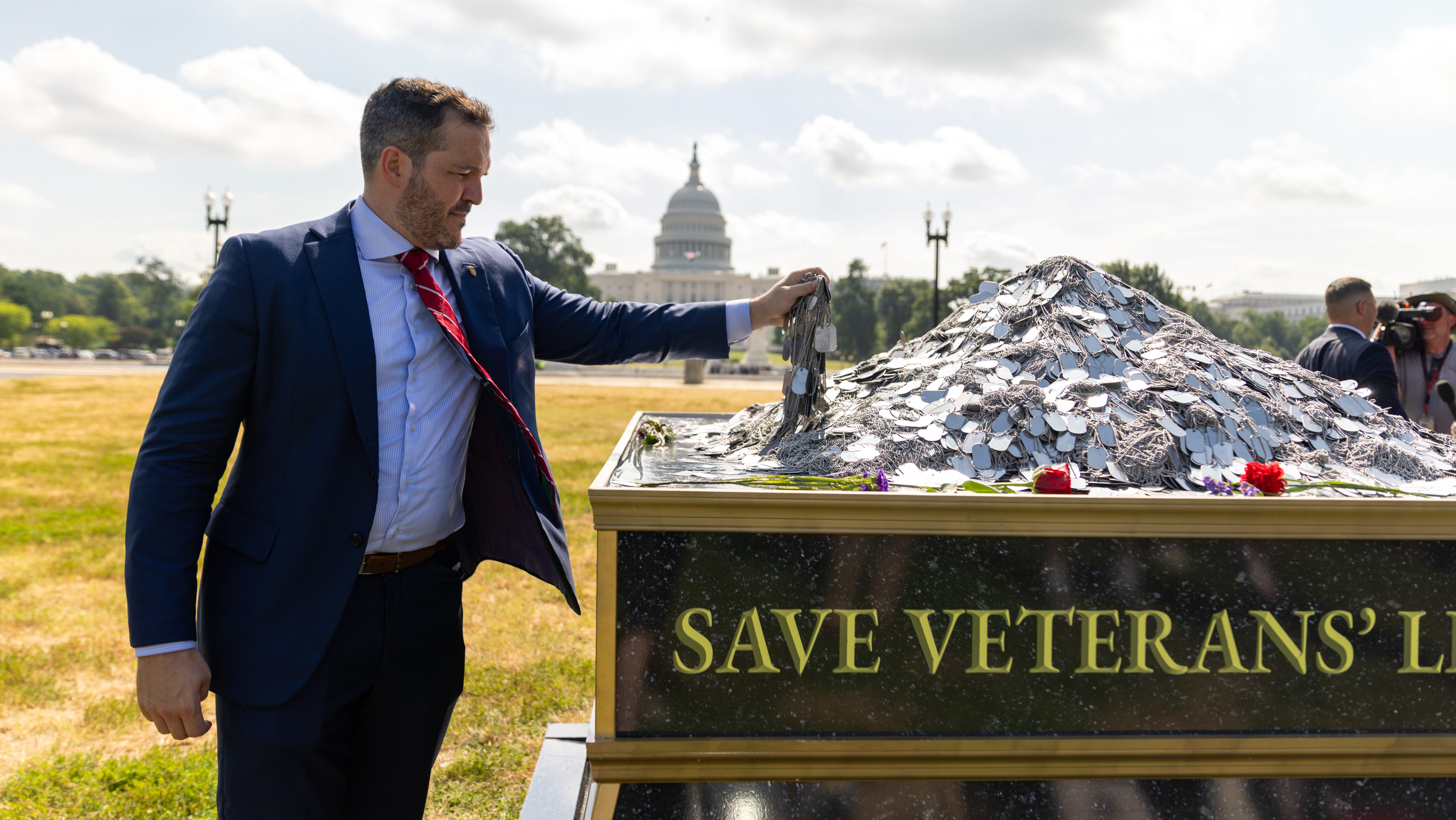 Michael Gould adding 17 sets of dog tags total 150,000 — representing the veteran suicides since 9/11.