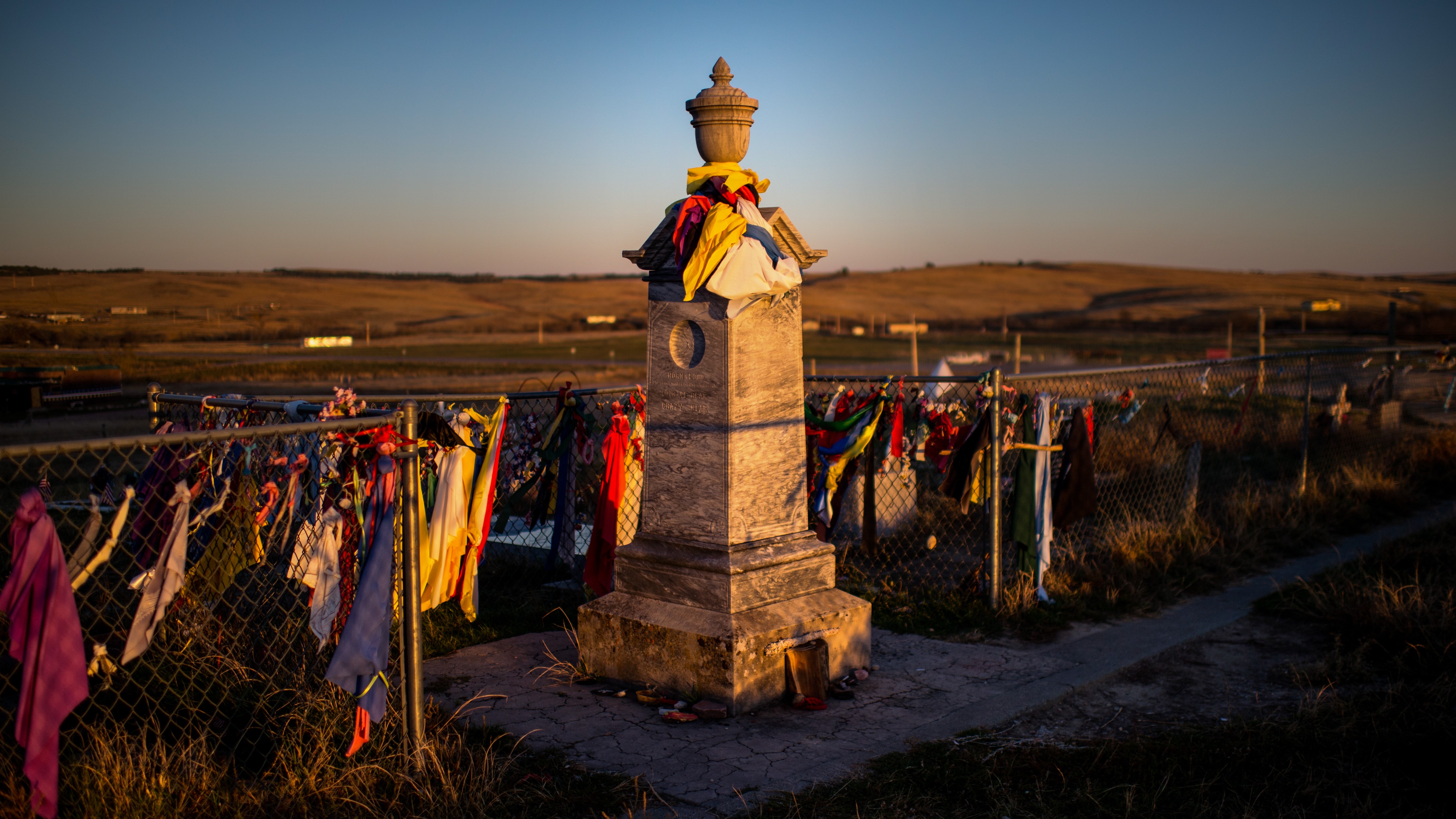 Wind flutters around the peace offerings of tobacco ties that line the fence at the Wounded Knee Memorial on Pine Ridge Reservation in South Dakota, on Monday, October 20, 2014. (Photo by Nikki Kahn/The Washington Post via Getty Images)