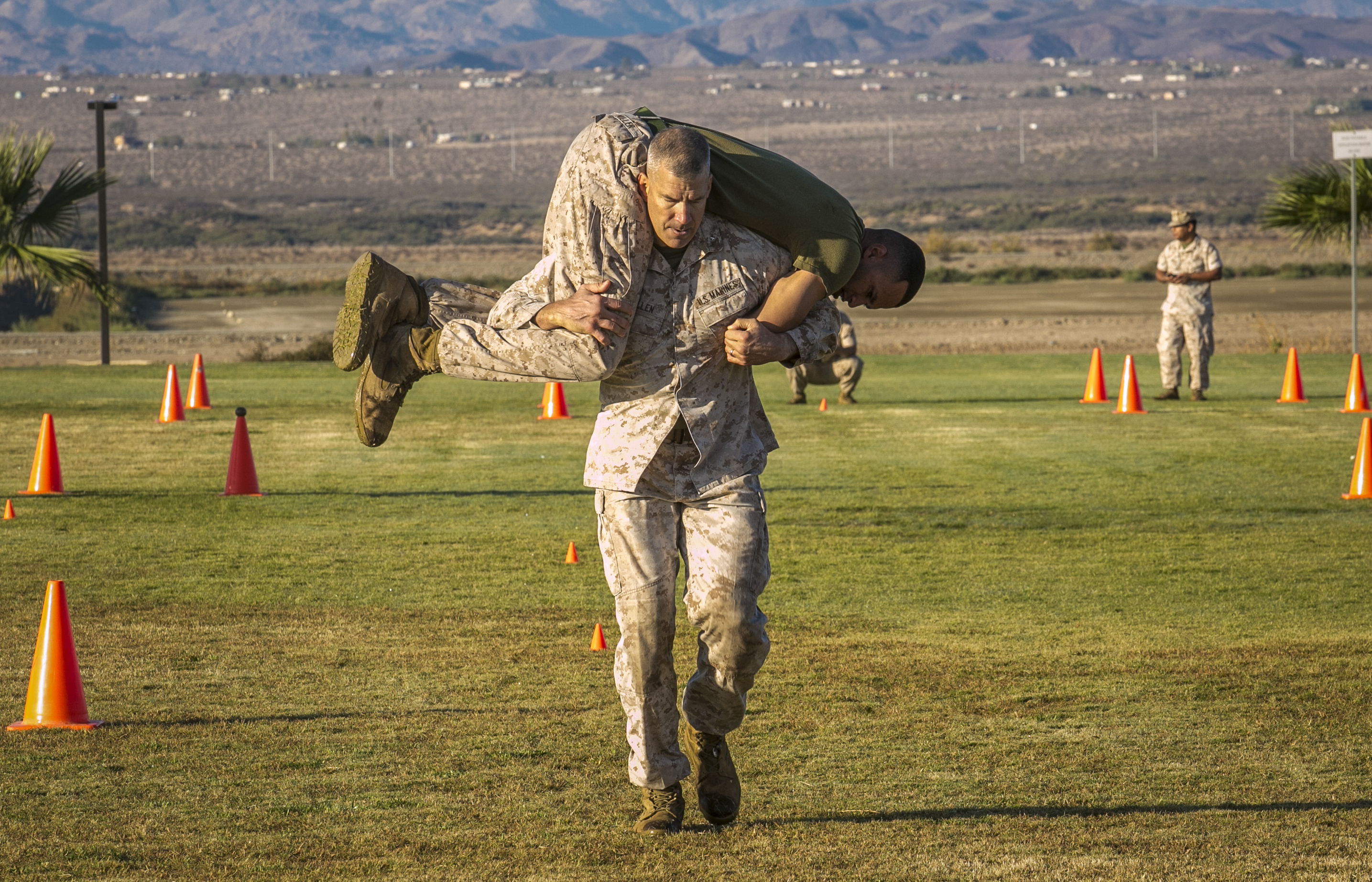 Brig. Gen. William F. Mullen III, Combat Center Commanding General, performs the fireman carry during the movement under fire portion of his Combat Fitness Test at Del Valle Field aboard Marine Corps Air Ground Combat Center, Twentynine Palms, Calif., Oct. 25, 2016. (Official Marine Corps photo by Lance Cpl. Dave Flores/Released)