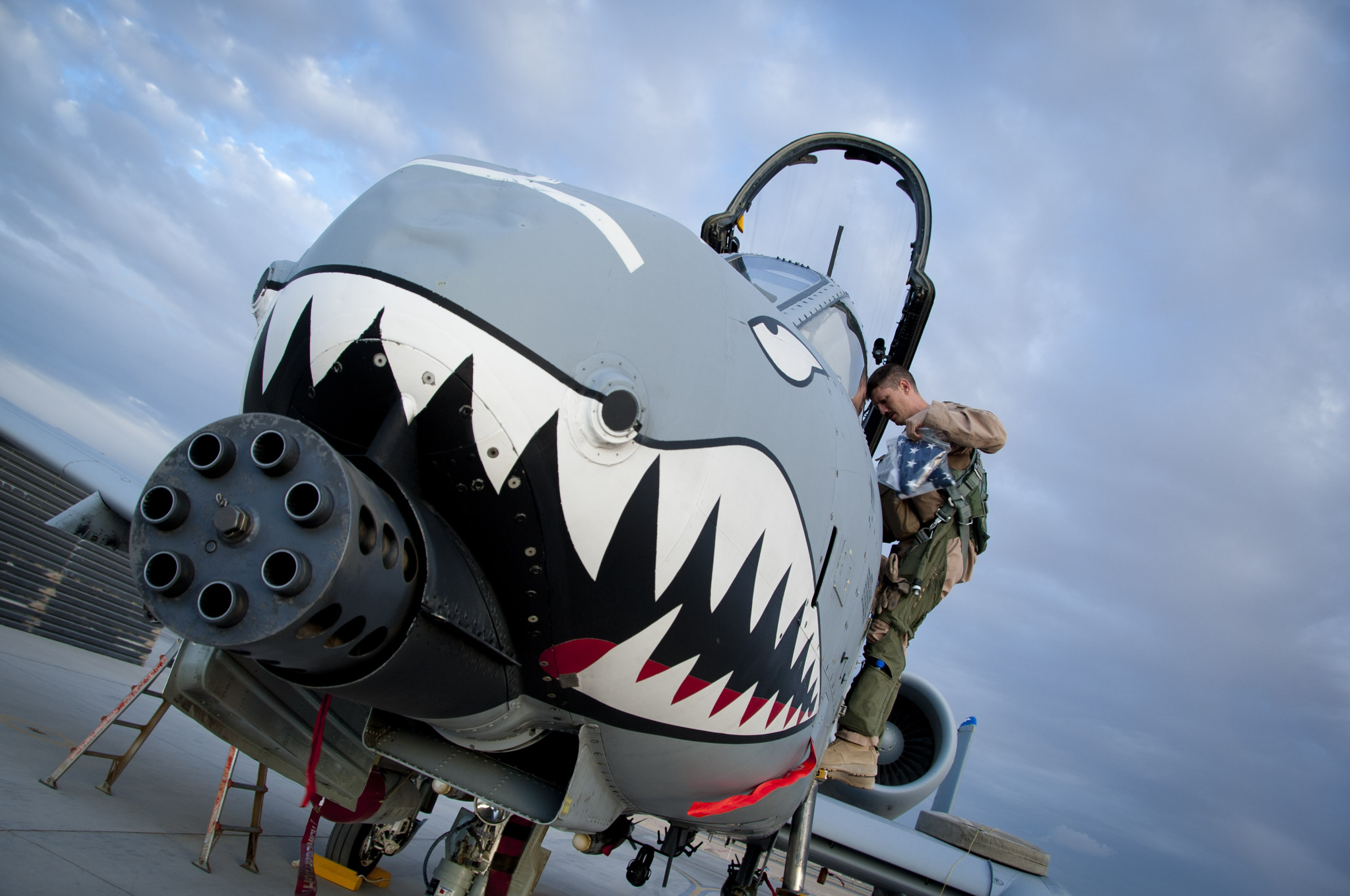 Capt. Richard Olson, 74th Expeditionary Fighter Squadron A-10 pilot, gets off an A-10 Warthog after his flight at Kandahar Airfield, Afghanistan, Sept. 2, 2011. The A-10's wide combat radius and short takeoff and landing capability permit operations in and out of locations near front lines.