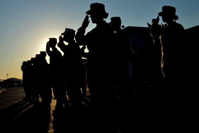 U.S. Marines salute during a formation on Marine Corps Air Station Miramar, Calif., Sept 4, 2012. Headquarters and Headquarters Squadron held the formation to recognize Marines being awarded and promoted.