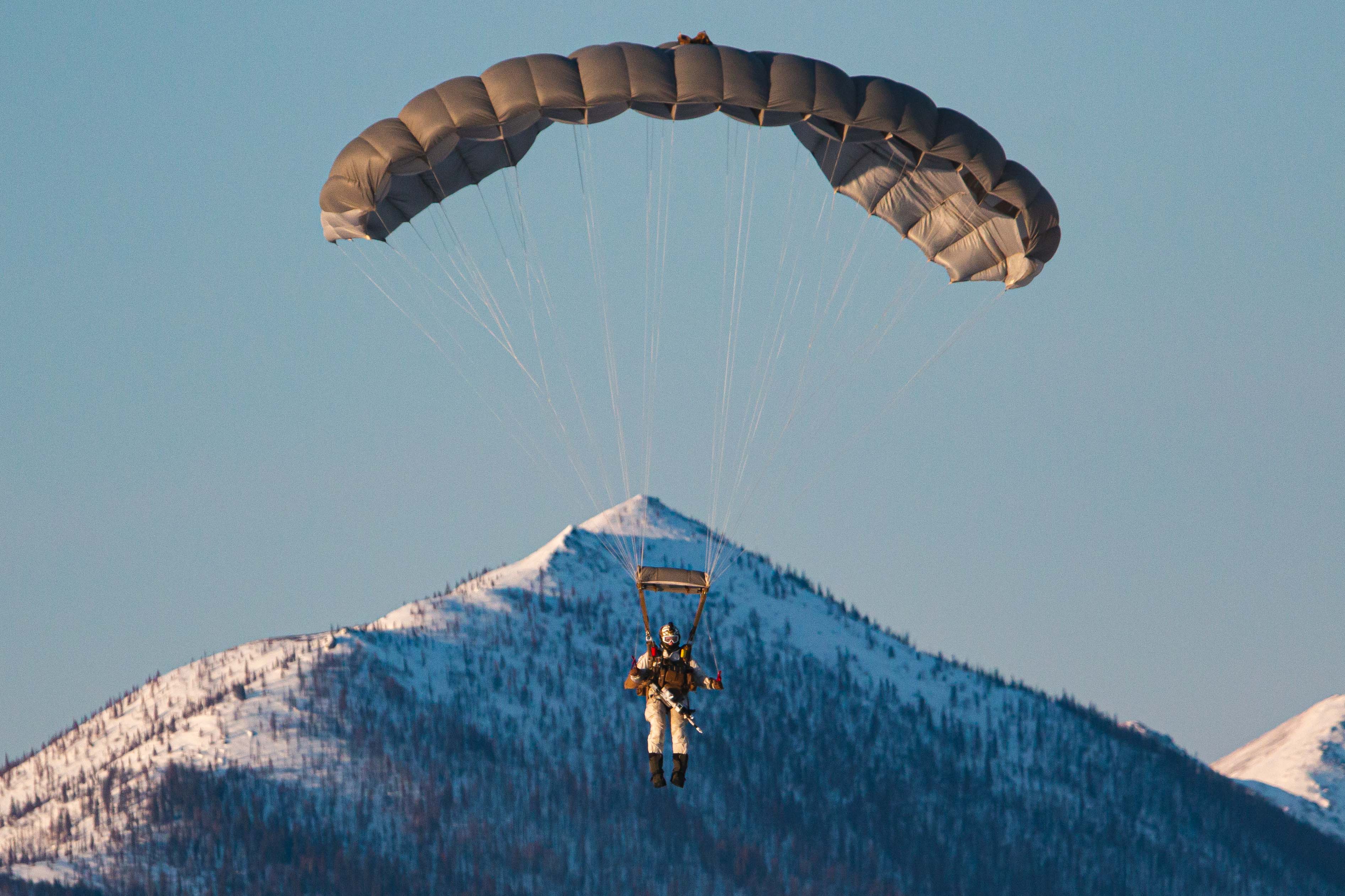 A 10th Special Forces Group (Airborne) Green Beret prepares to land after conducting freefall operations in the Artic Circle as part of the Joint Pacific Multinational Readiness Center on March 31, 2023. Conducting freefalling operations in freezing temperatures prepares Green Berets to adapt and perform regardless of the adversities presented by the environment. (U.S. Army photo by Sgt. Luis M. Solorio)