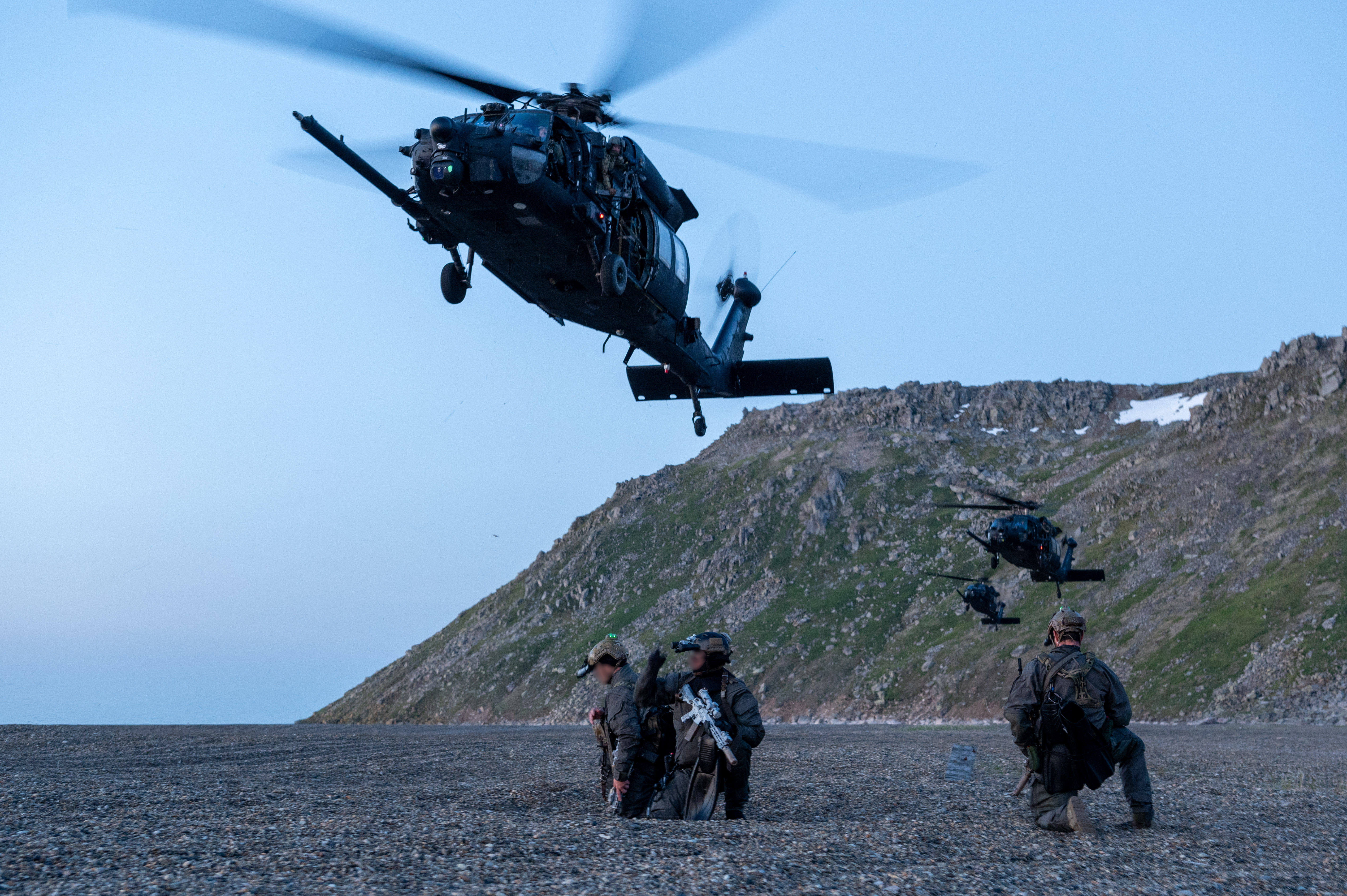 U.S. East Coast-based Naval Special Warfare Operators (SEALs) await extraction from the beach of Gambell, Saint Lawrence Island, Alaska, by U.S. Army MH-60M Blackhawk helicopters assigned to the 160th Special Operations Aviation Regiment (Airborne) as part of Operation Polar Dagger, July 22, 2024. Operation Polar Dagger provided Special Operations Command North the opportunity to refine a range of capabilities and response options to deter, disrupt, degrade, and deny competitor activity in the Arctic in support of U.S. Northern Command and layered defense of the homeland. (U.S. Air Force photo by Senior Airman Johnny Diaz)