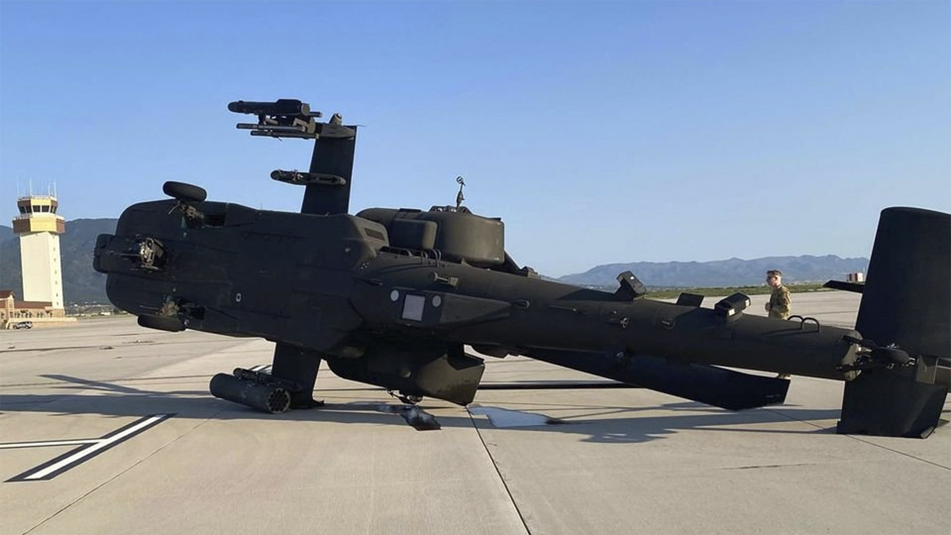 A helicopter knocked on its side after storms hit Fort Carson. (image courtesy US Army WTF Moments)