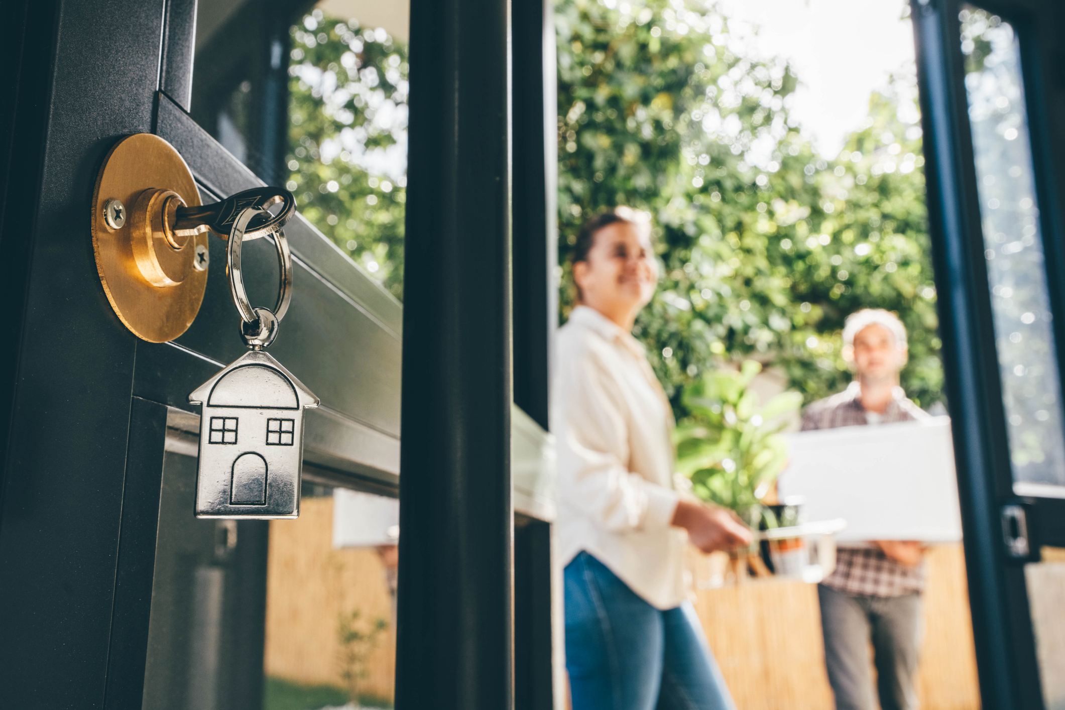 Couple celebrating moving day, mortgage, and relocation concept.