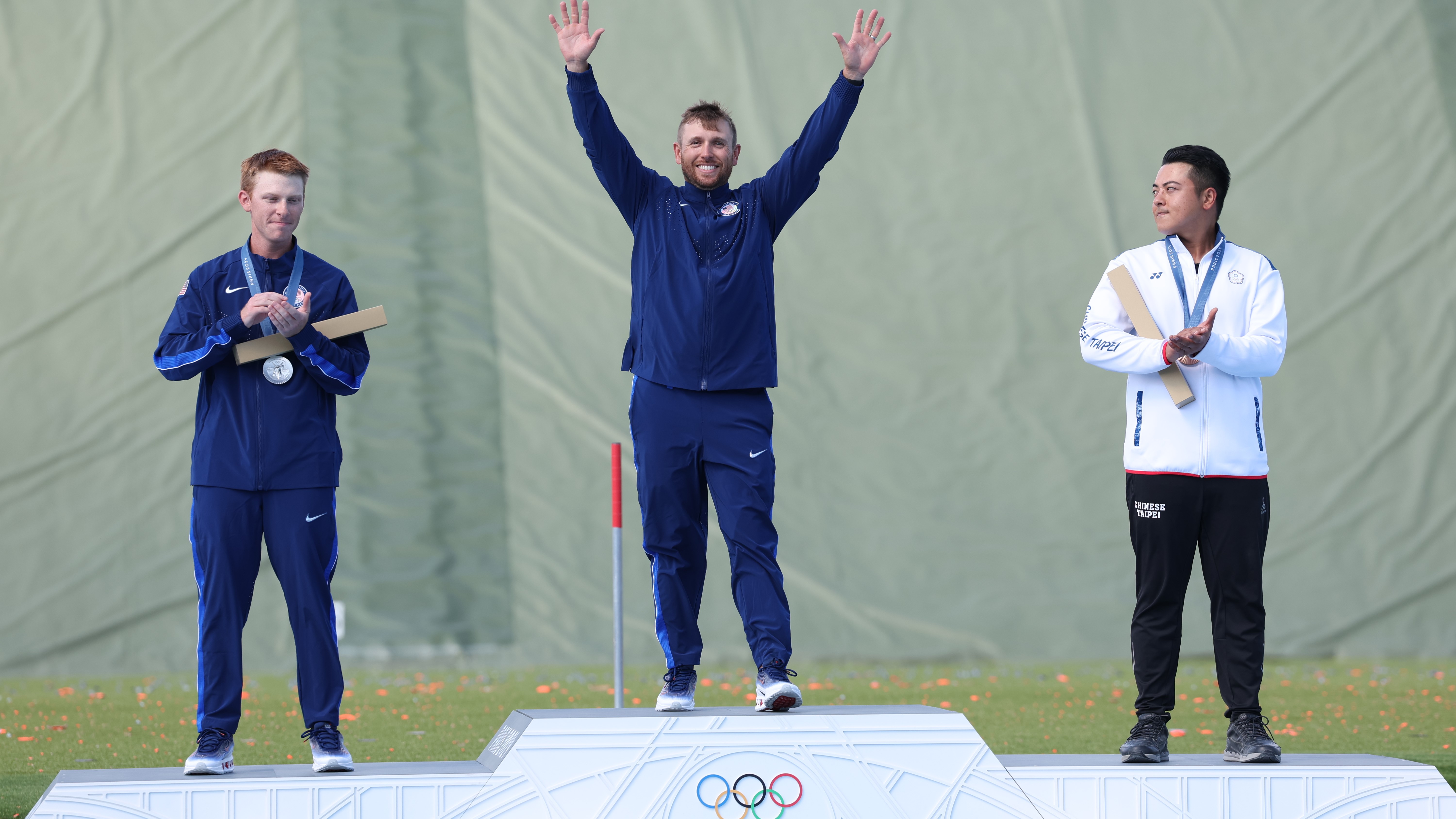 CHATEAUROUX, FRANCE - AUGUST 03: Gold medalist Vincent Hancock of Team United States (C), silver medalist Conner Lynn Prince of Team United States (L) and bronze medalist Meng Yuan Lee of Team Chinese Taipei (R) celebrate on the podium at the Shooting Skeet Men’s medal ceremony on day eight of the Olympic Games Paris 2024 at Chateauroux Shooting Centre on August 03, 2024 in Chateauroux, France. (Photo by Charles McQuillan/Getty Images)