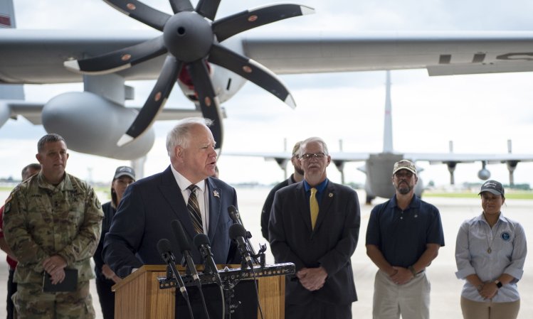 Minnesota Gov. Tim Walz in front of a then-unique Minnesota Air National Guard C-130H3, which has an 8-propeller blade. ANG photo by Amy M. Lovgren.