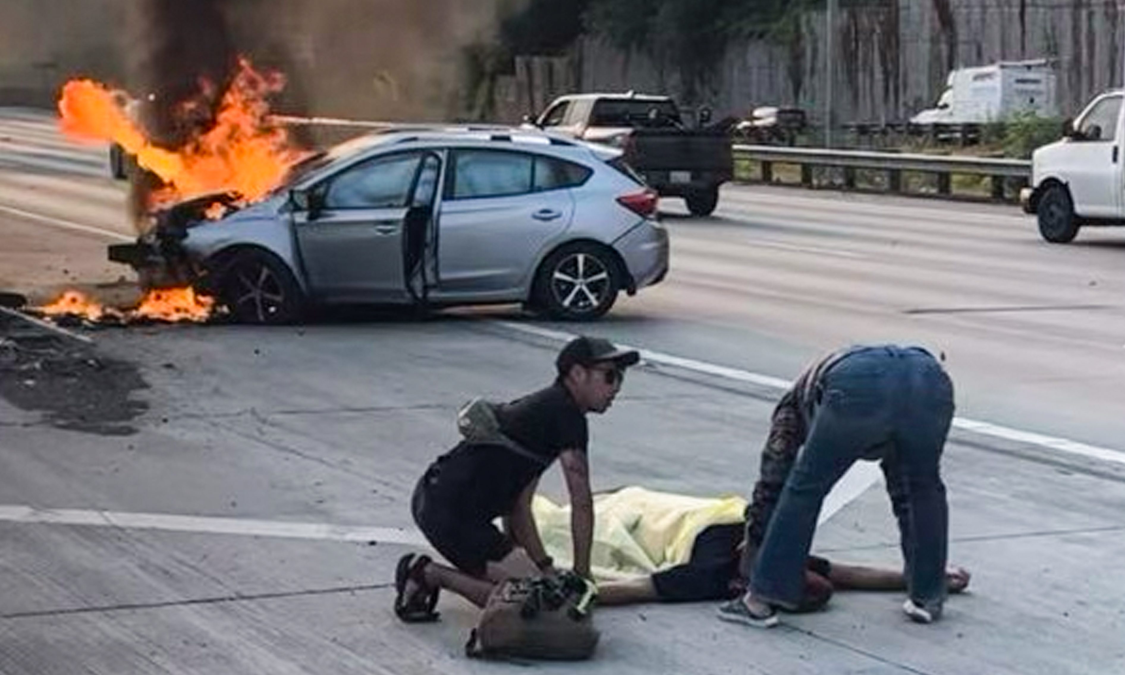 Ranger Joe Thach assessing the driver he pulled from a burning car.