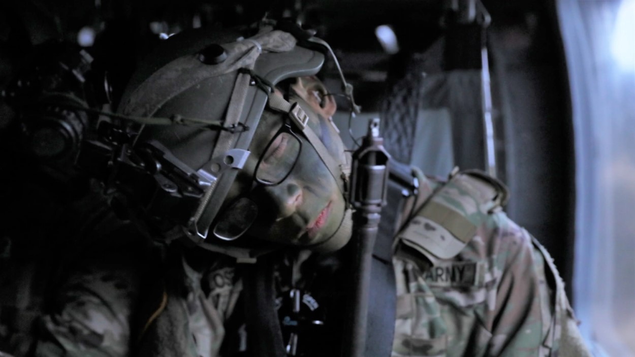 An Army soldier sleeps while in transport at Hohenfels Training Area, Germany in February 2021. (photo by Sgt. John W. Todd/U.S. Army)