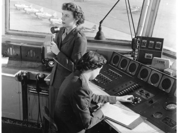 Female Marines perform their duties as traffic controllers during the Korean War. During the war, women were encouraged to take on more roles in different military occupations than before to free up more men for combat.