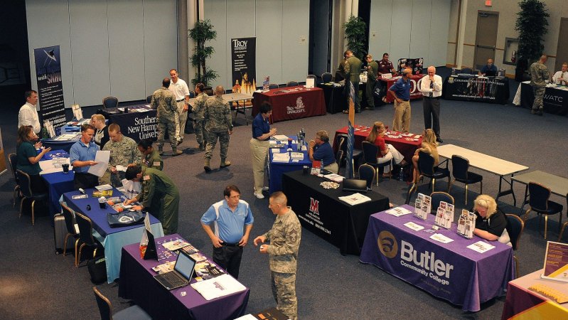 Team McConnell Airmen receive information from colleges and universities during the annual education fair held in the Robert J. Dole Community Center ballroom June 19, 2012, McConnell Air Force Base, Kan. The fair was held to spread knowledge of the different programs for Airmen and their family members.