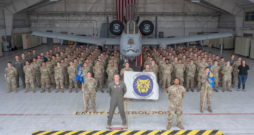 The 354th Fighter Generation Squadron poses for a group photo for the final time at Davis-Monthan Air Force Base, Ariz., June 24, 2024. The 354th FGS maintained A-10C aircraft to conduct close air support, forward air control, airborne, and combat search and rescue for theater commanders worldwide. (U.S. Air Force photo by Airman 1st Class William Finn V)