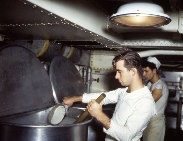 Sailors cook within the close quarters of a United States Navy cruiser's galley, in the Pacific Theater, World War II. (Photo by PhotoQuest/Getty Images)