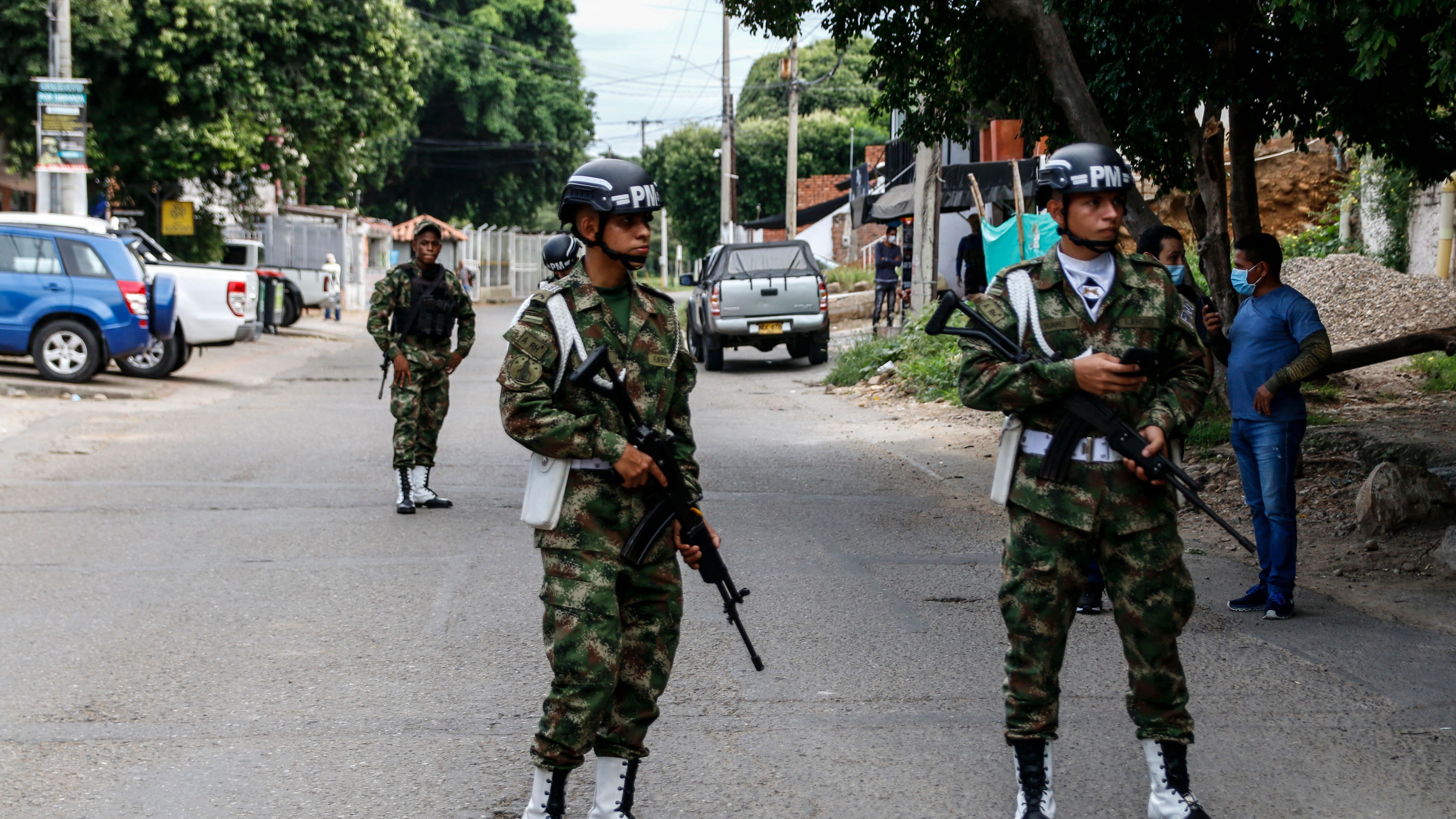 Colombian soldiers stand outside of a military base on the street following a bombing inside the base on June 15, 2021. (Getty photo via AFP by Schneyder Mendoza)