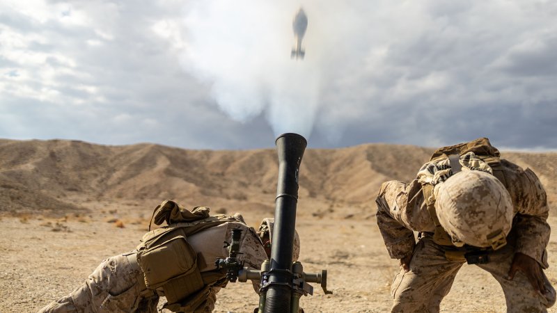 Marines fire a mortar.