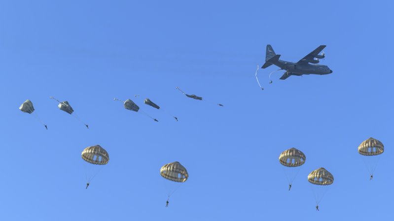 Several paratroopers jump out of an Air Force C-130H over Arnhem, the Netherlands.