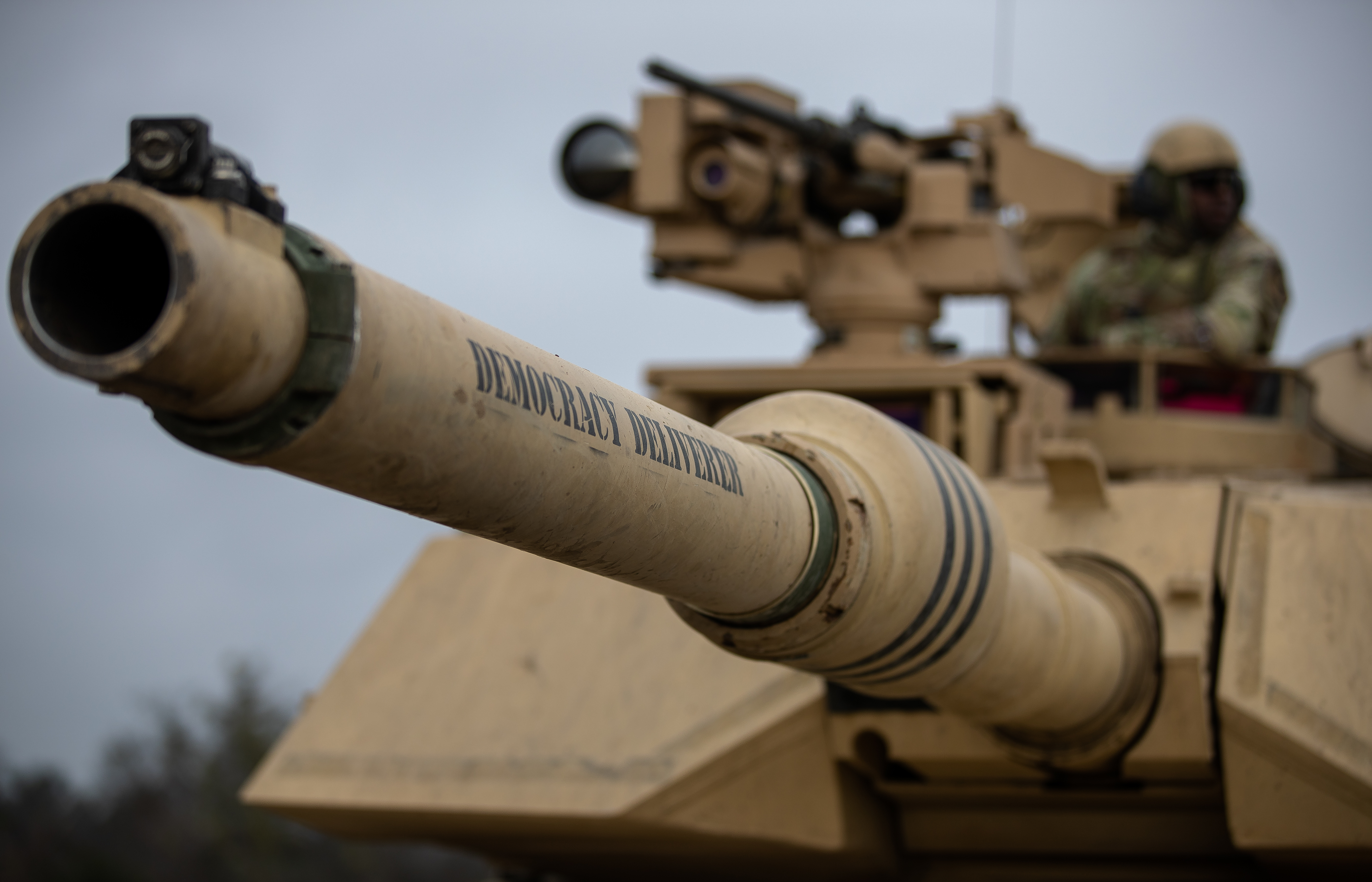 A tank named "Democracy Deliverer" stages prior to entering the live-fire range during the combined arms live-fire exercise (CALFEX) Feb. 5.