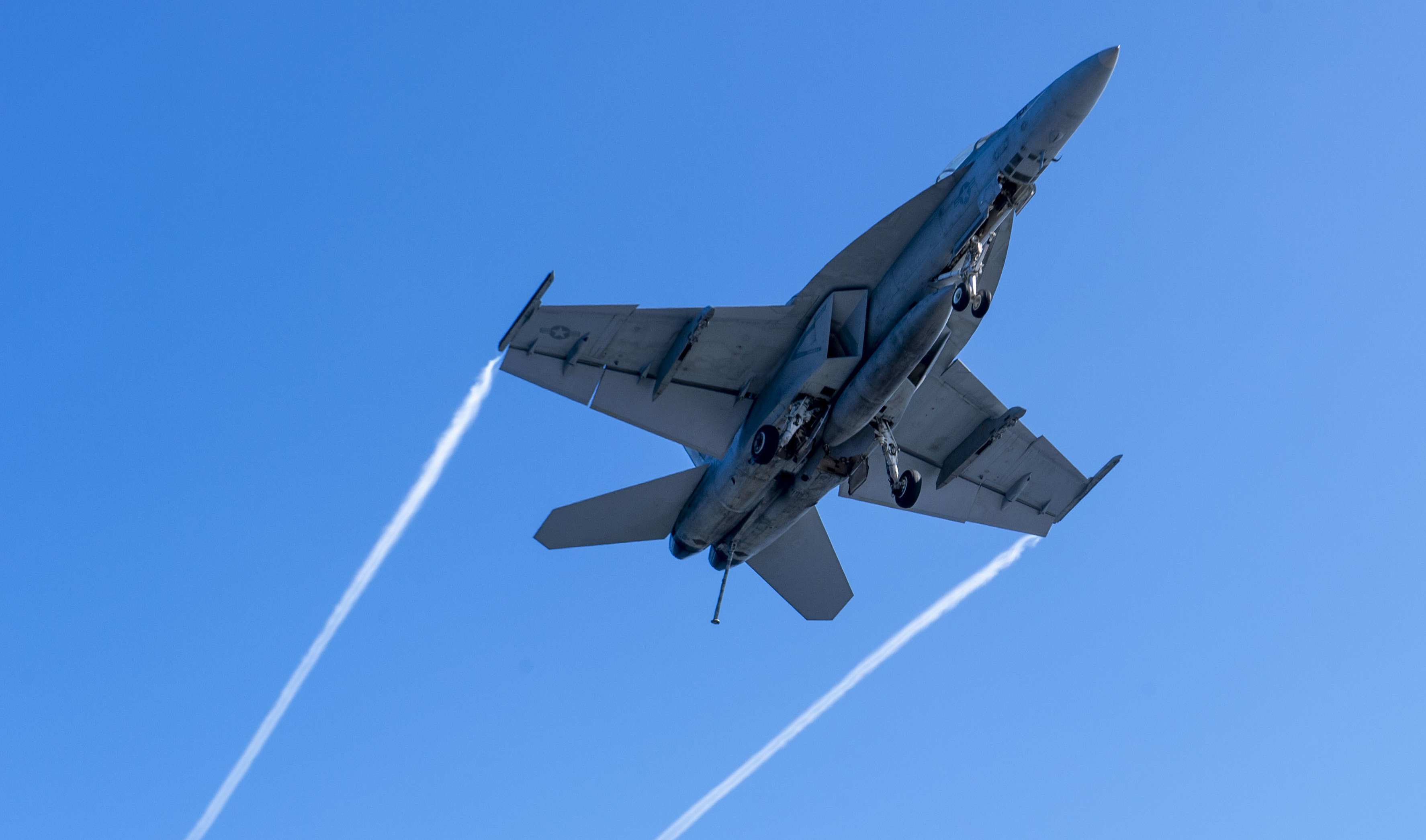 220309-N-DU622-1001 PACIFIC OCEAN (Mar. 9), An F/A-18F Super Hornet, from the "Flying Eagles" of Strike Fighter Squadron (VFA) 122, flies over the flight deck of the aircraft carrier USS Nimitz (CVN 68). Nimitz is underway conducting routine operations. (U.S. Navy photo by Mass Communication Specialist 3rd Class Justin McTaggart)