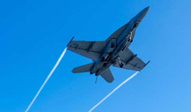 220309-N-DU622-1001 PACIFIC OCEAN (Mar. 9), An F/A-18F Super Hornet, from the "Flying Eagles" of Strike Fighter Squadron (VFA) 122, flies over the flight deck of the aircraft carrier USS Nimitz (CVN 68). Nimitz is underway conducting routine operations. (U.S. Navy photo by Mass Communication Specialist 3rd Class Justin McTaggart)