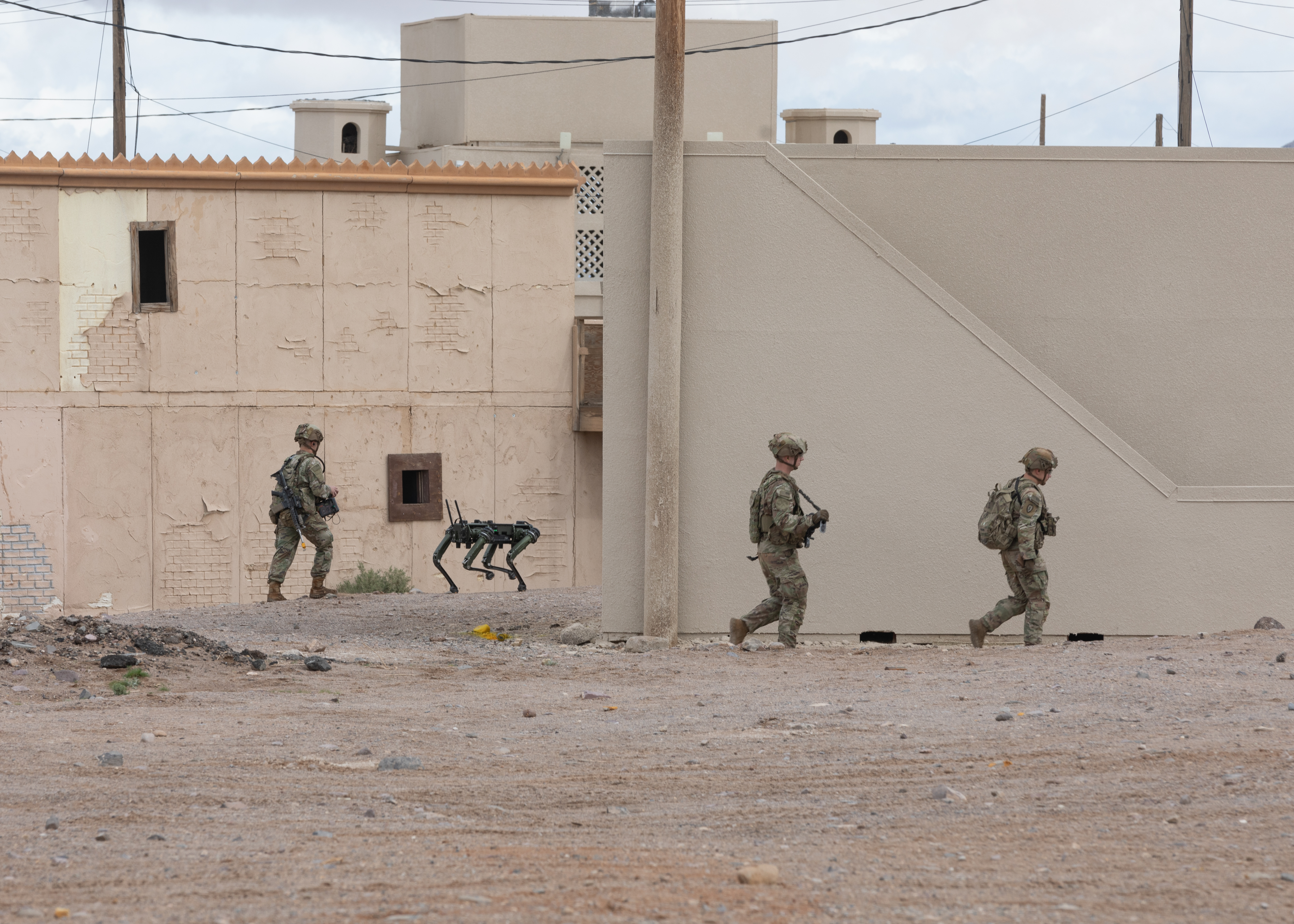 A Quadruped Ghost robotic dog is deployed as part of an urban assault during a series of Human Machine Integration experiments in a training environment as part of Project Convergence – Capstone 4 at Fort Irwin, Calif., March 16, 2024. Quadrupeds are midsized, high endurance, agile unmanned ground vehicles that provide enhanced situational awareness and support for frontline Soldiers, acting as their eyes and ears (U.S. Army photo by Spc. Marquis McCants)